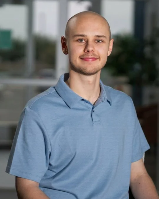 Pastor Jordan Gerdes, Associate Pastor, smiling in a studio portrait wearing a light blue polo shirt.