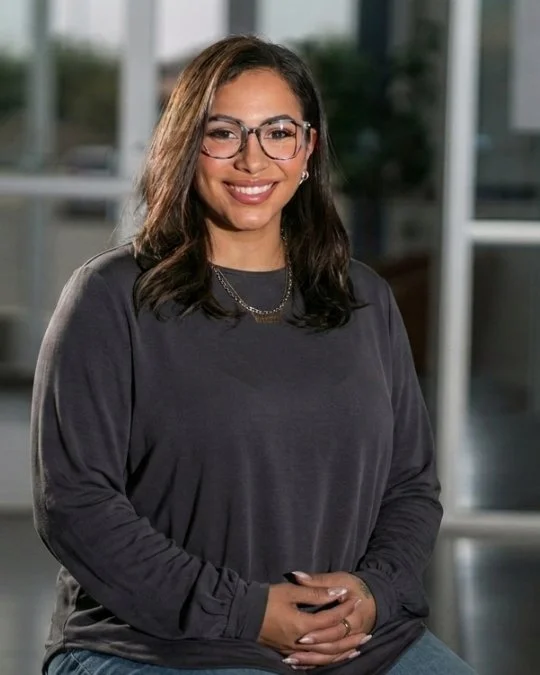 Jocelyn Bonilla, WRSHP Leader, smiling in a studio portrait wearing a dark blouse and glasses.