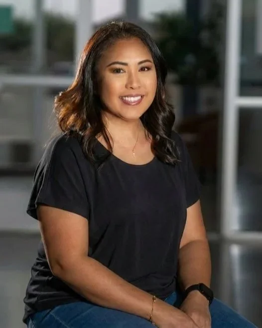 Cheryl Kelly, Social Media Coordinator, seated in a studio portrait wearing a black blouse.