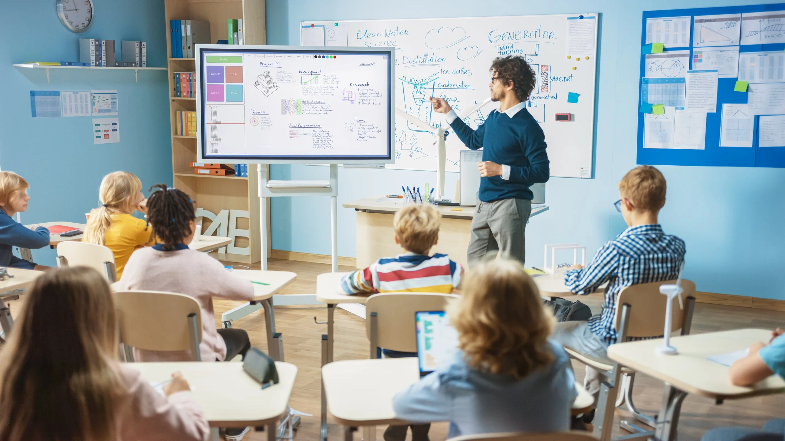 Teacher in bright room instructing students with interactive screen