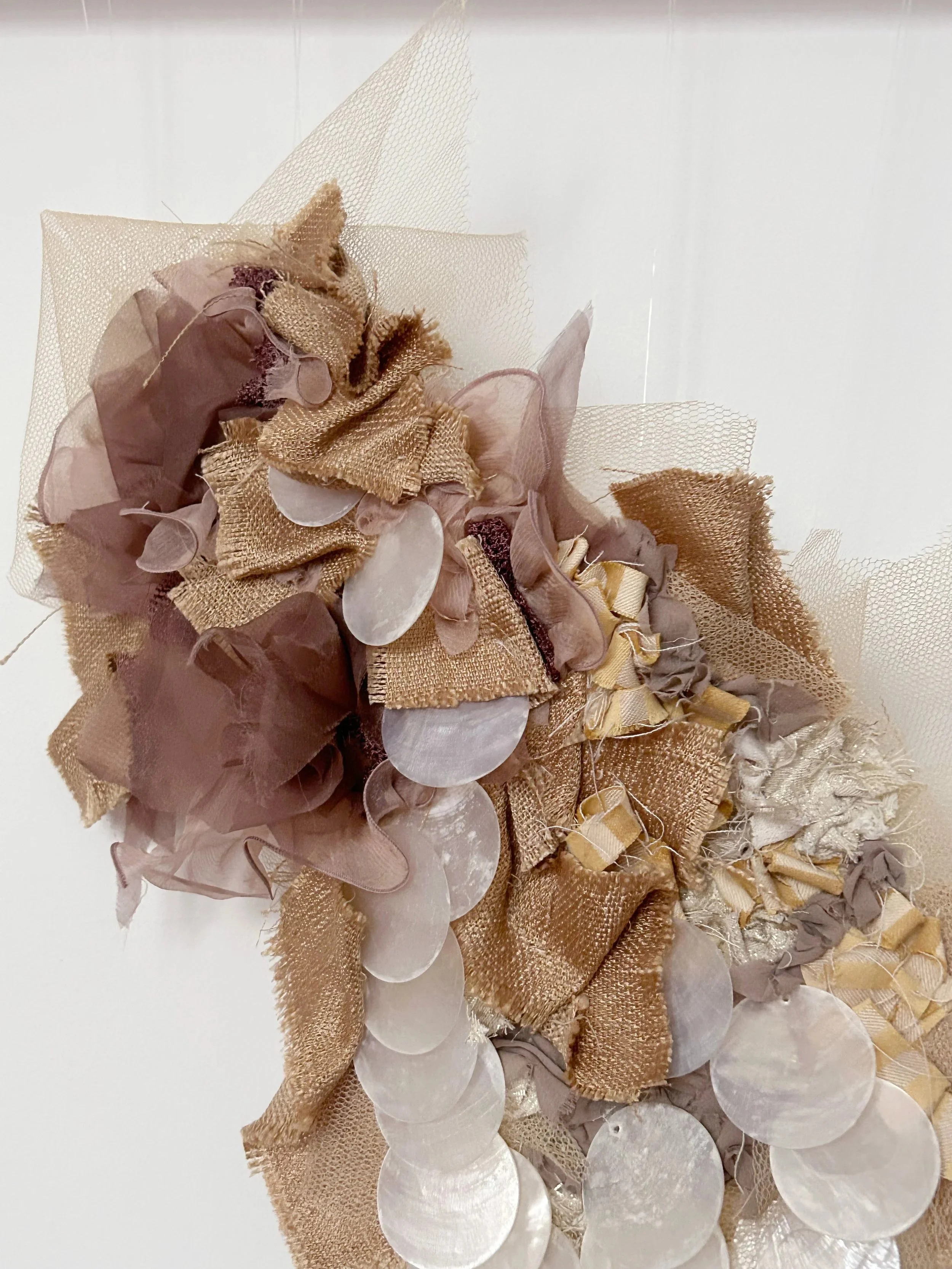 Luna 1 - A soft composition of layered textiles, shaped by memory and touch. Each fragment is hand-stitched, inviting reflection on fragility and transformation.