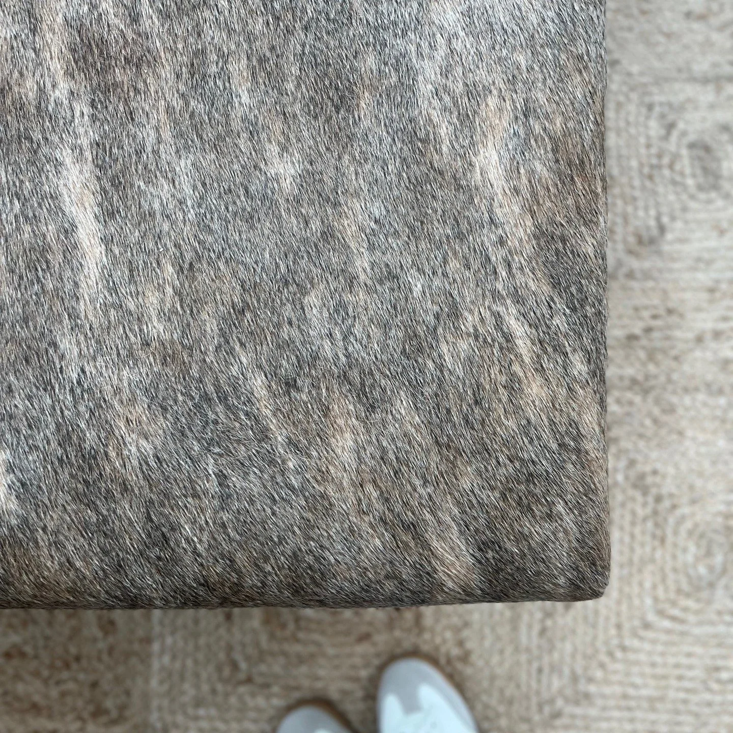 We had so much fun styling and furnishing this office space. We started with a blank white space and used texture and earthy colors to warm up the space. This brindle hide ottoman sort of stole the show in the entryway.

And, side bonus - loved worki