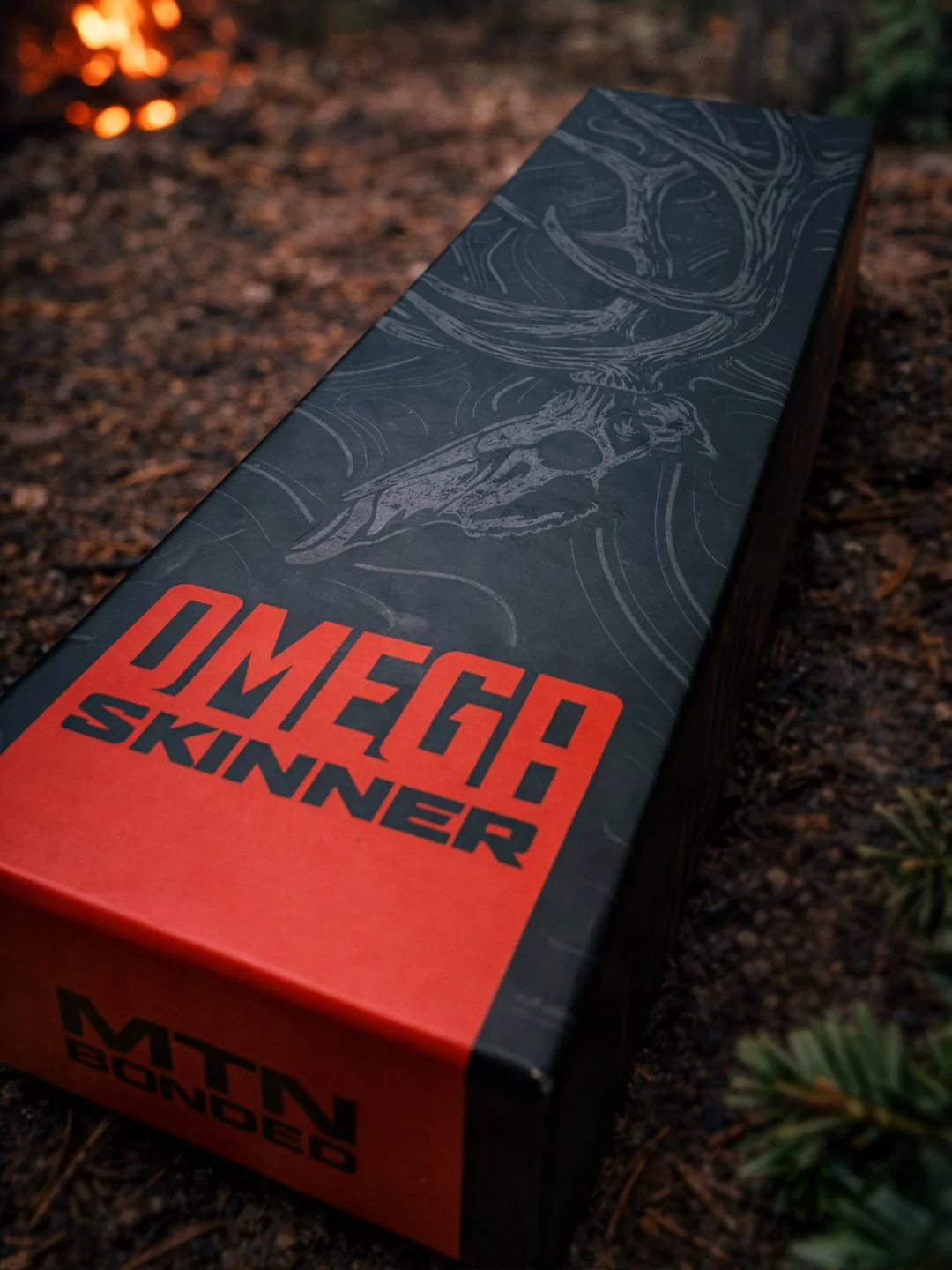 Premium hunting knife packaging design for the Omega Skinner featuring bold typography and custom elk skull illustration.