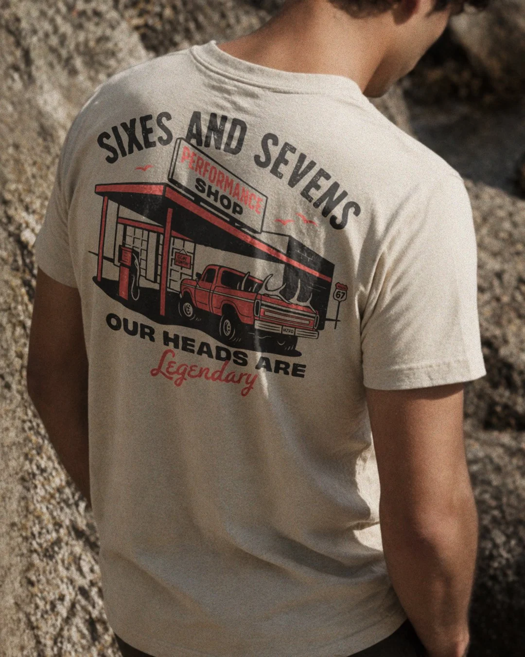 Mockup of a custom hunting lifestyle t-shirt featuring a vintage gas station and elk hunting illustration.