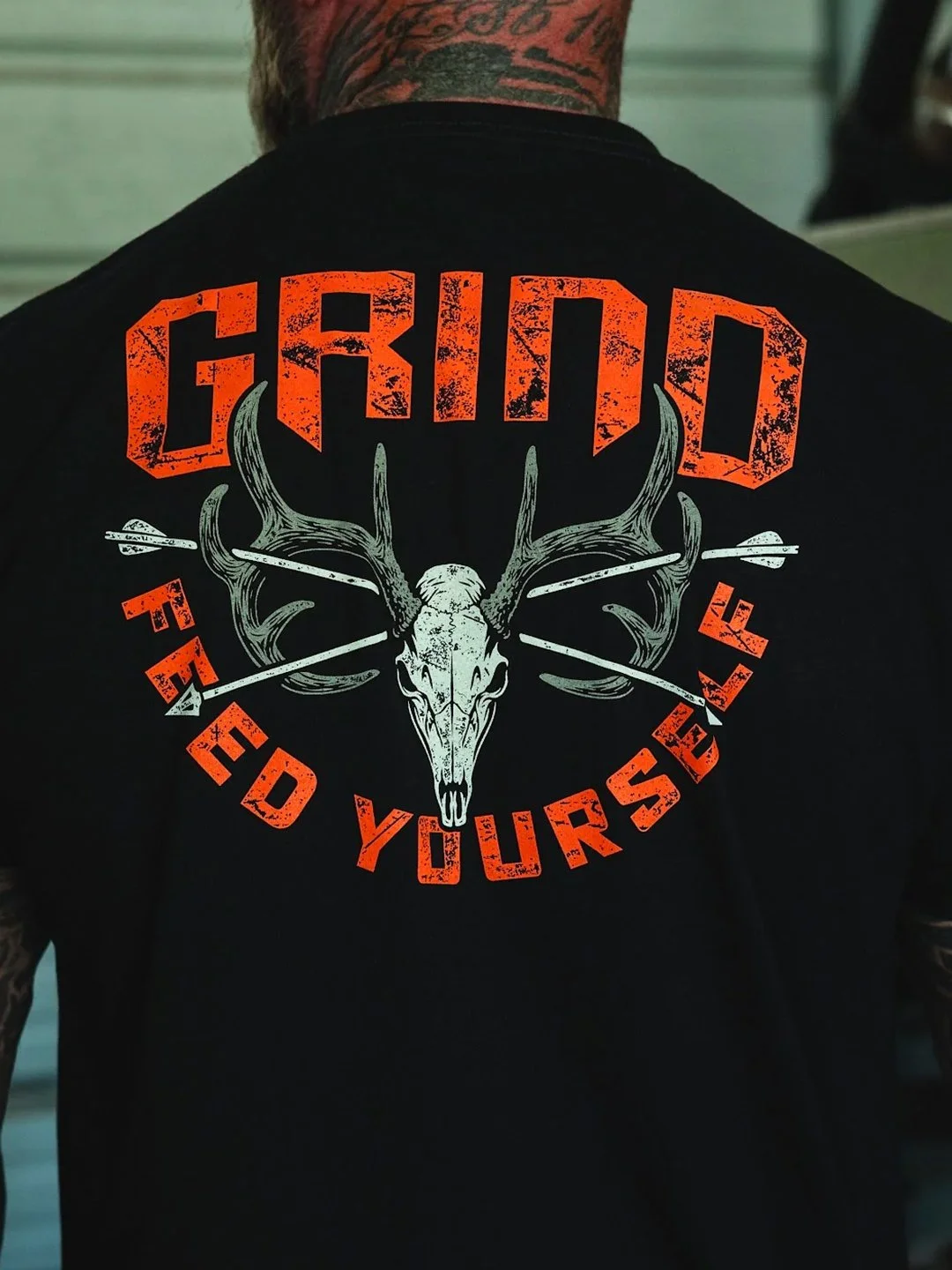 Hunting apparel graphic for The Grind Athletics featuring custom typography, deer skull illustration, and distressed orange print layout.