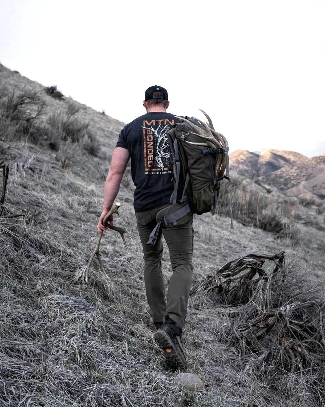 Hunter hiking with MTN Bonded elk antler graphic on shirt