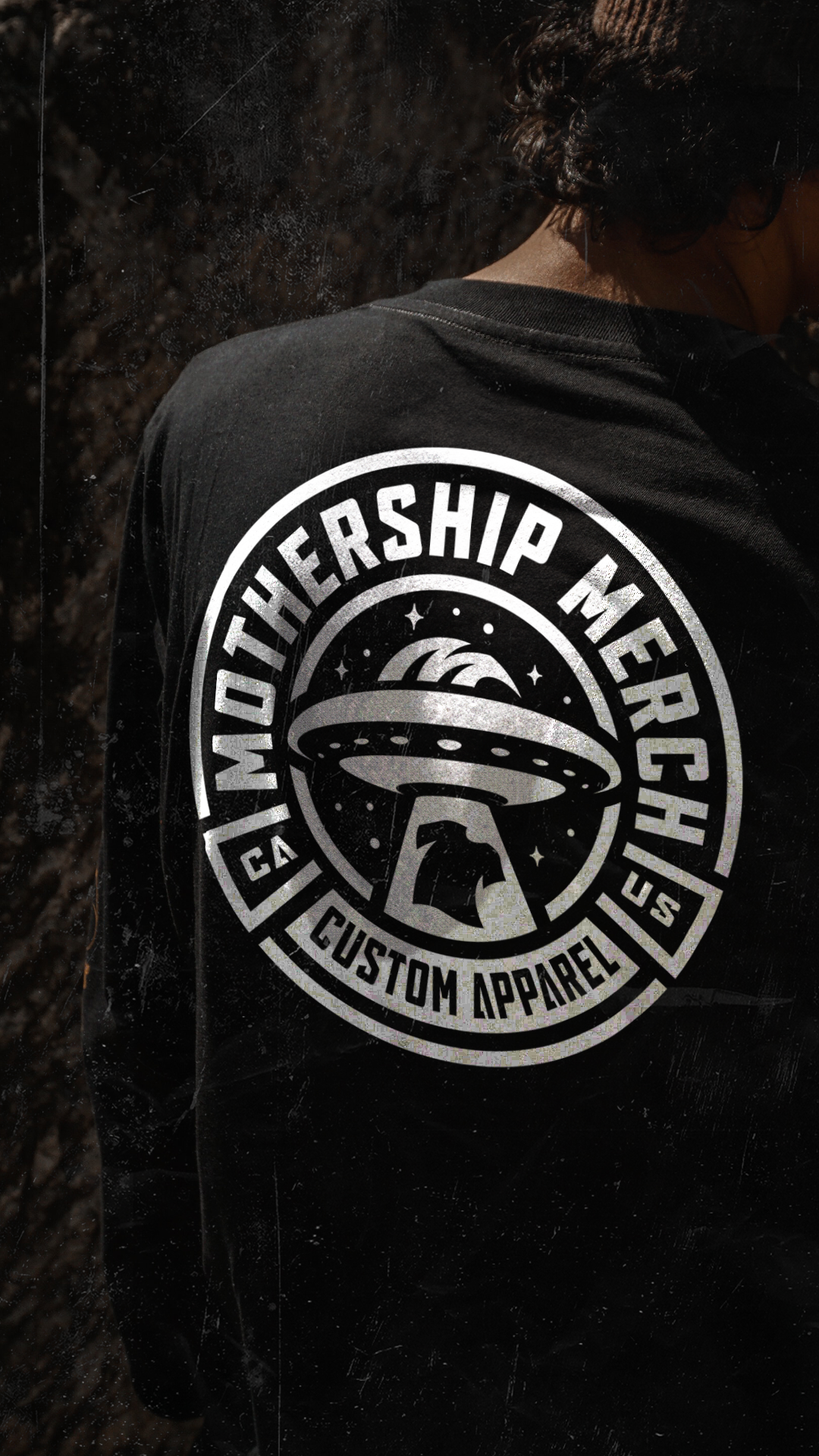 Mothership Merch custom UFO logo printed on the back of a black shirt