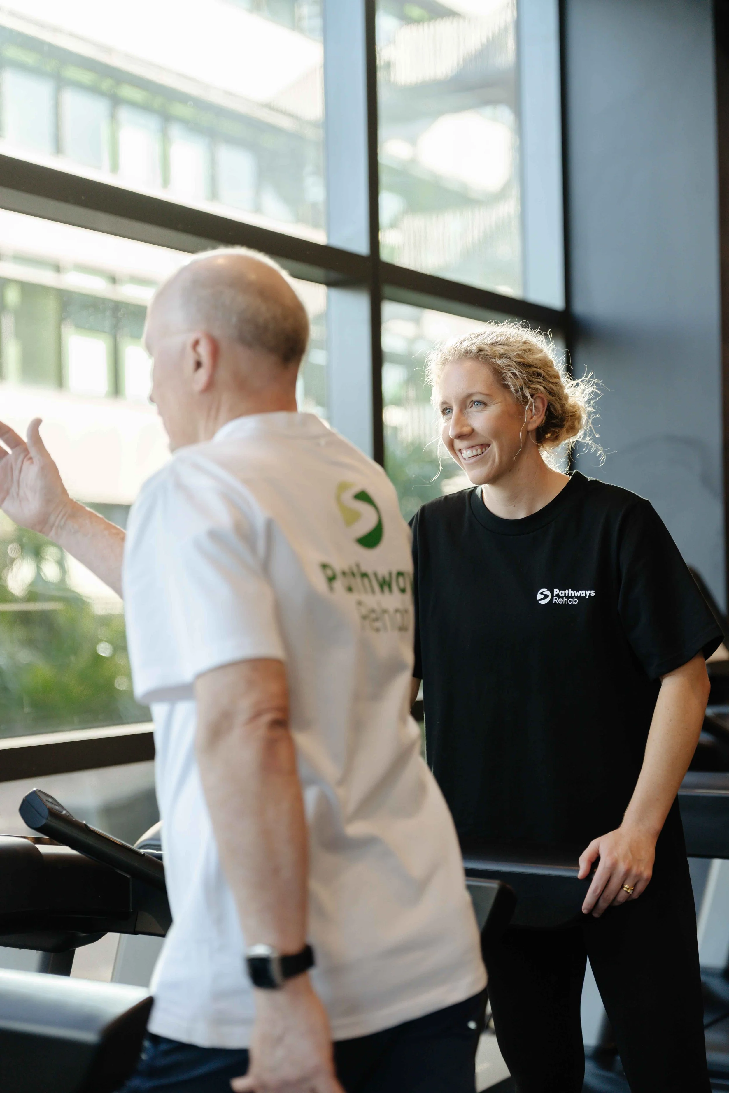 Pathways Rehab brand and specialist Kate working with her participant in a gym for mobile physiotherapy.