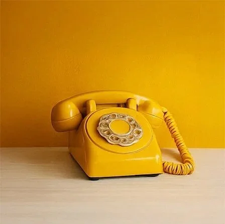 A yellow vintage phone symbolizes taking a courageous step toward connection and intentional dating.