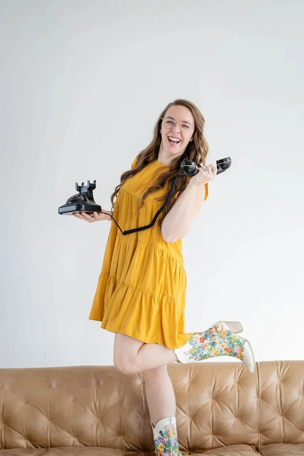 Madigan, founder of CommitmentISM, holds a vintage phone, illustrating the importance of conversational chemistry in intentional dating.