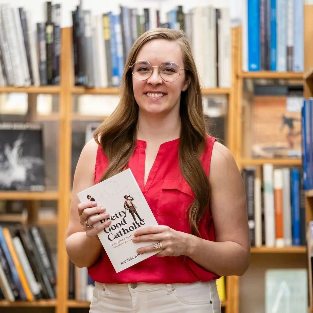 Madigan, founder of CommitmentISM, holds a Catholic book on dating, reflecting thoughtful formation and faith-centered guidance.