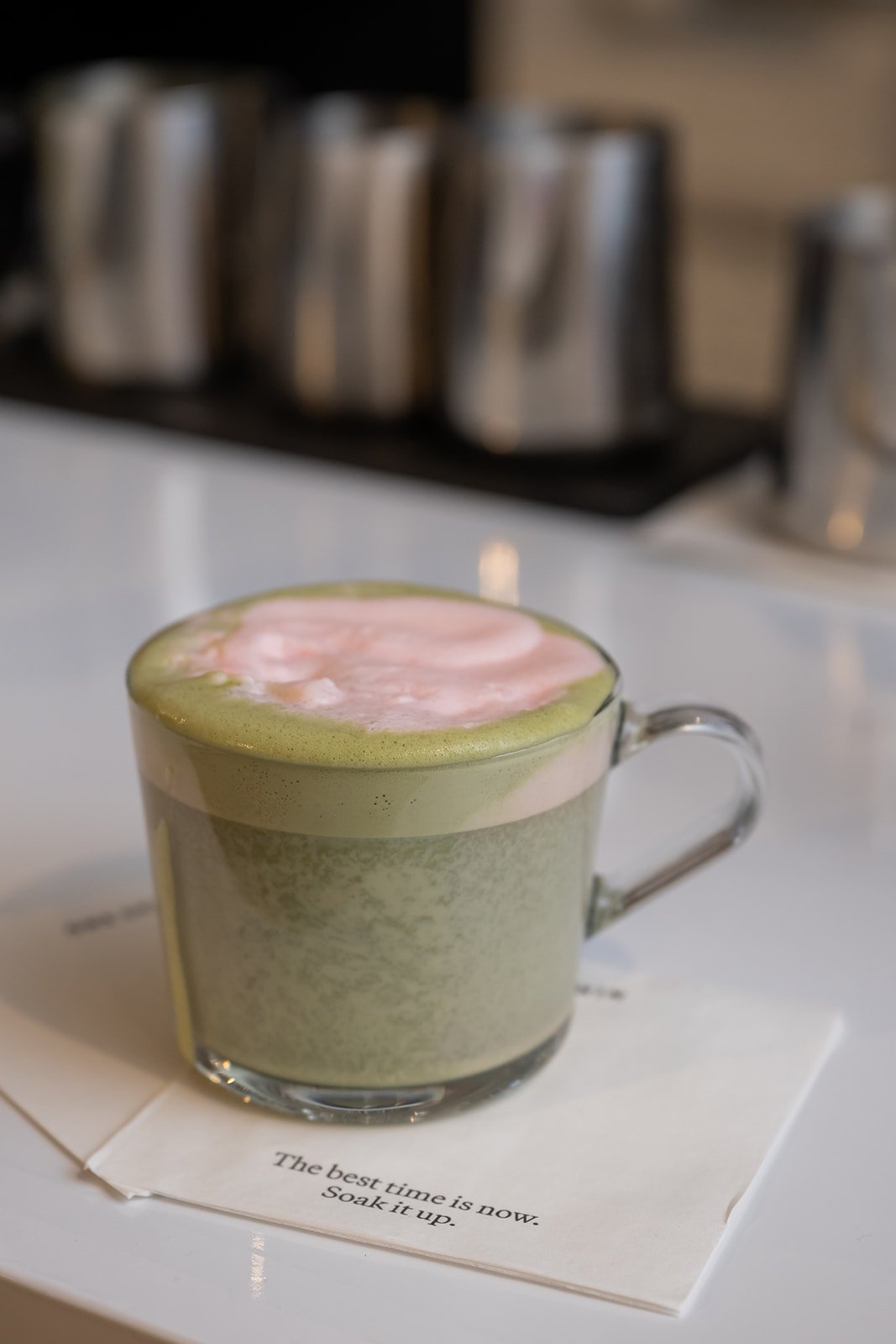 Luxury influencer event beverage featuring matcha latte with pink foam at OneSkin brand experience