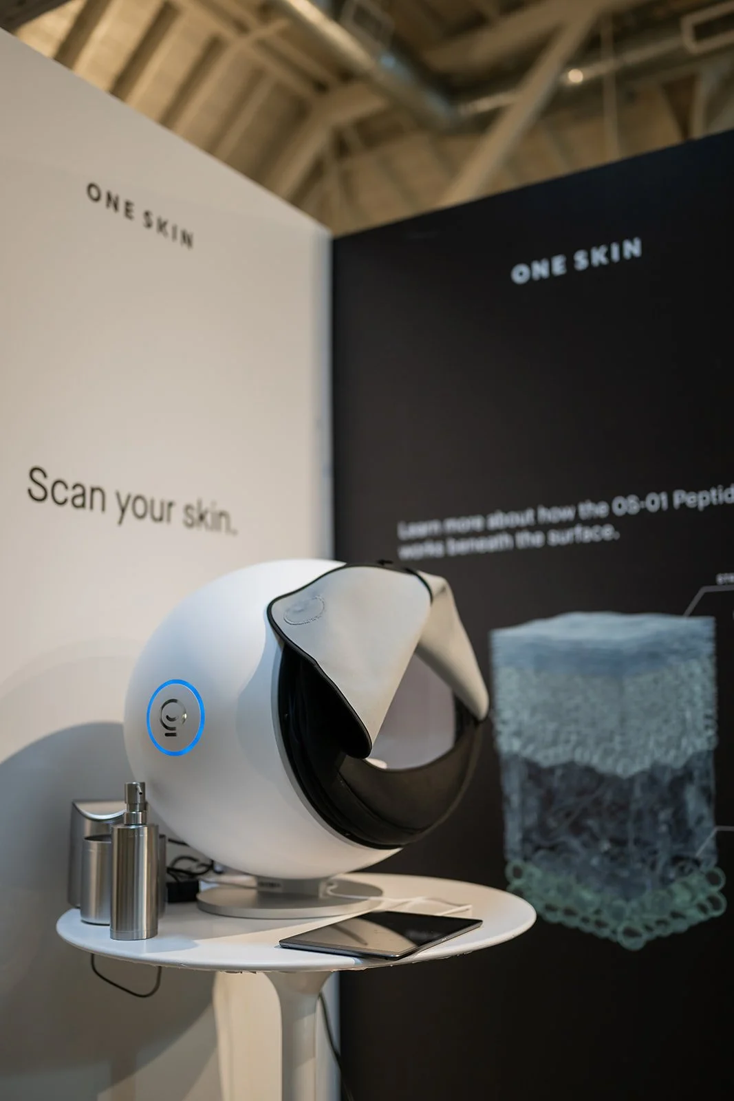 OneSkin product education display showcasing skincare benefits at influencer brand event