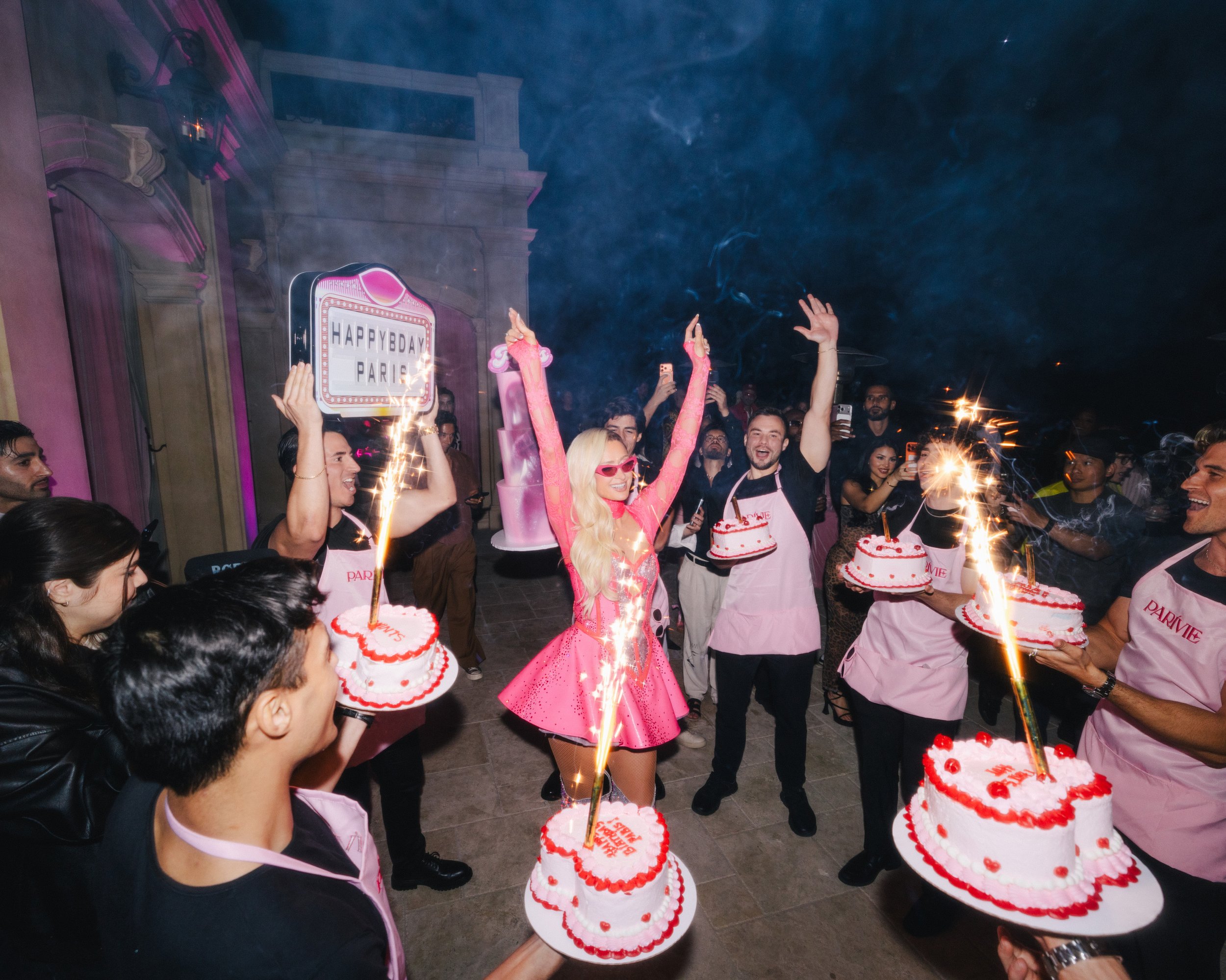 Custom cake presentation and branded aprons designed for Paris Hilton’s birthday party by Loriann Serna of The Wife of the Party.