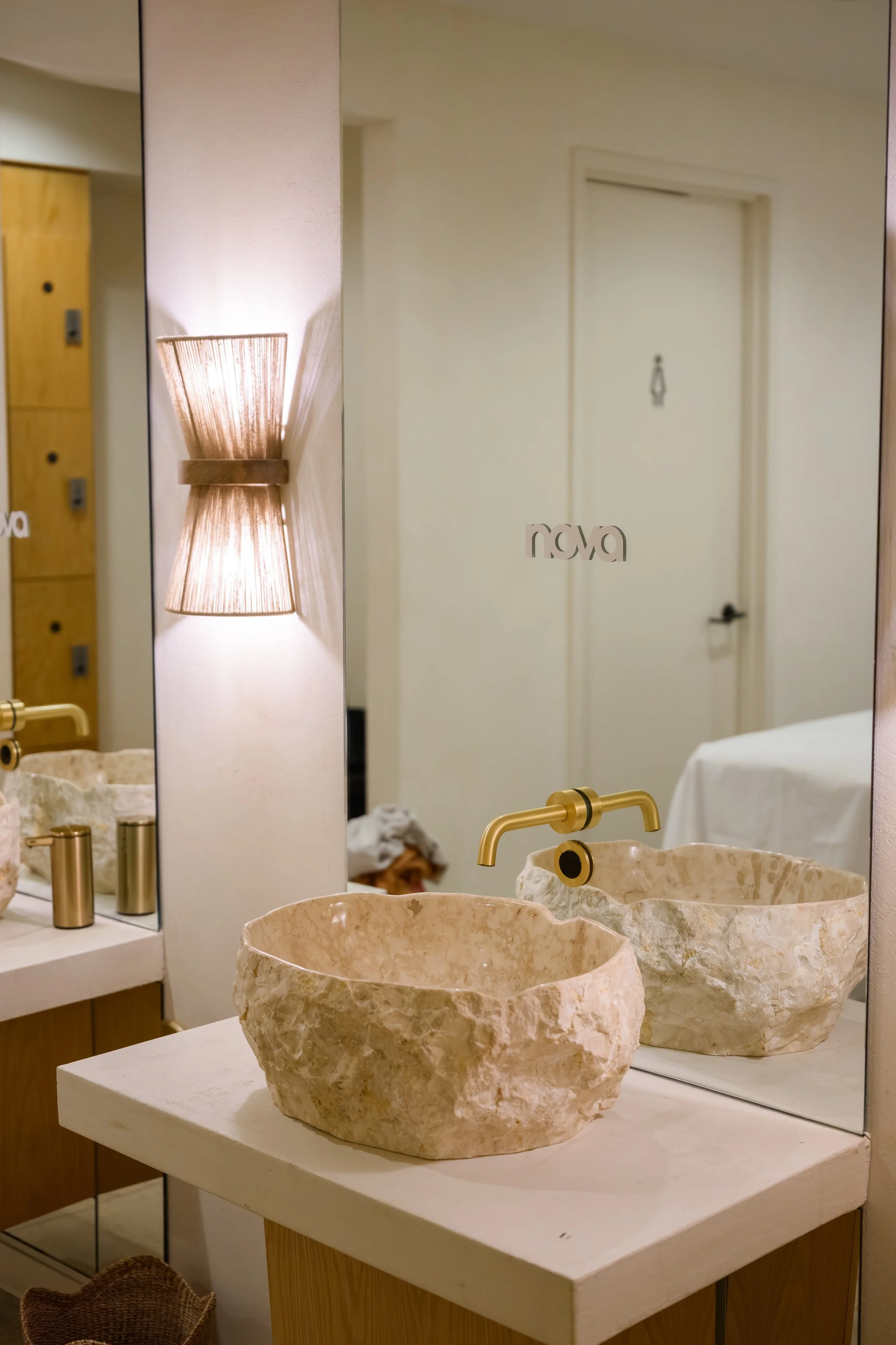 Nova Fitness apparel displayed in boutique fitness studio with Nova branded mirror and modern activewear racks at Fashion Nova launch produced by Wife of the Party