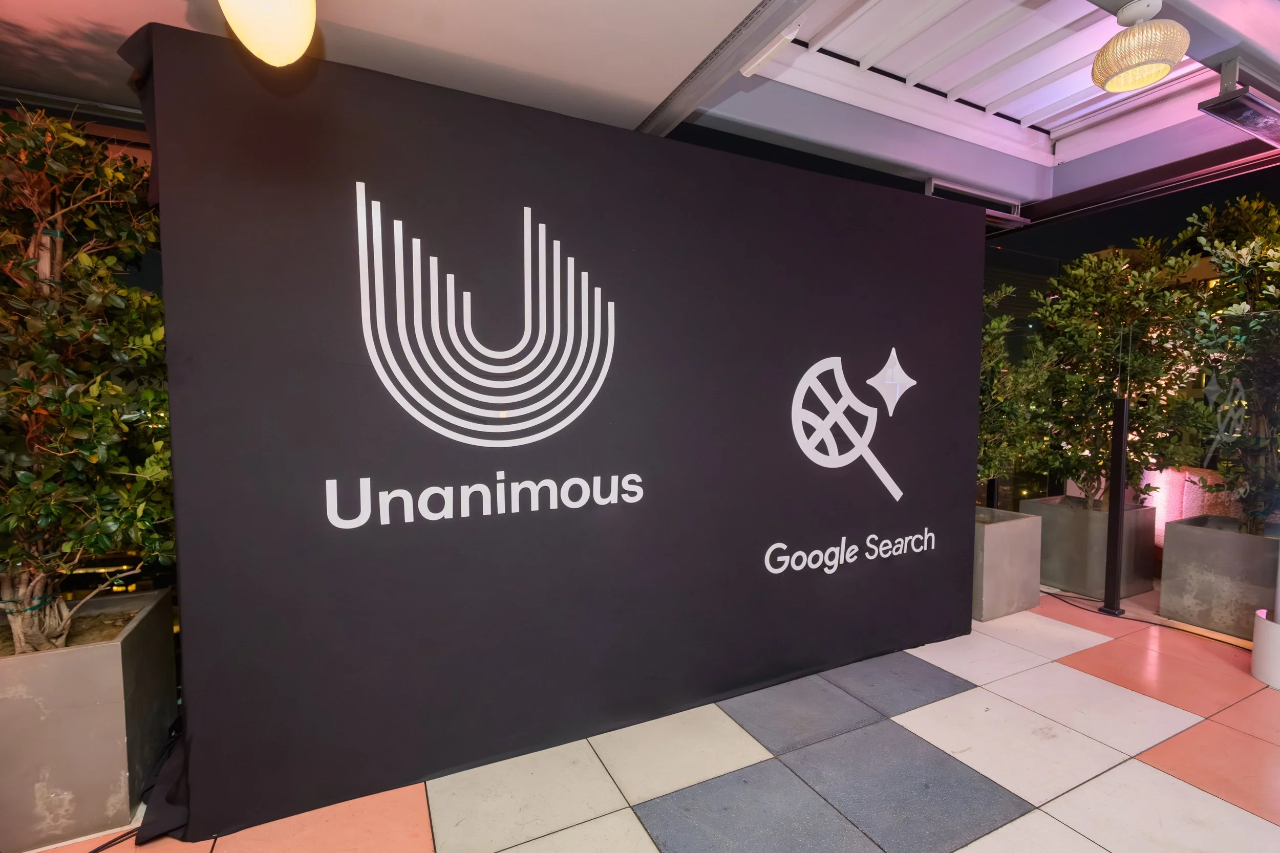 Custom Unanimous and Google Search step-and-repeat branding installation created for Stephen Curry’s NBA All-Star Weekend event, featuring sleek black-and-white design by Loriann Serna and The Wife of the Party.