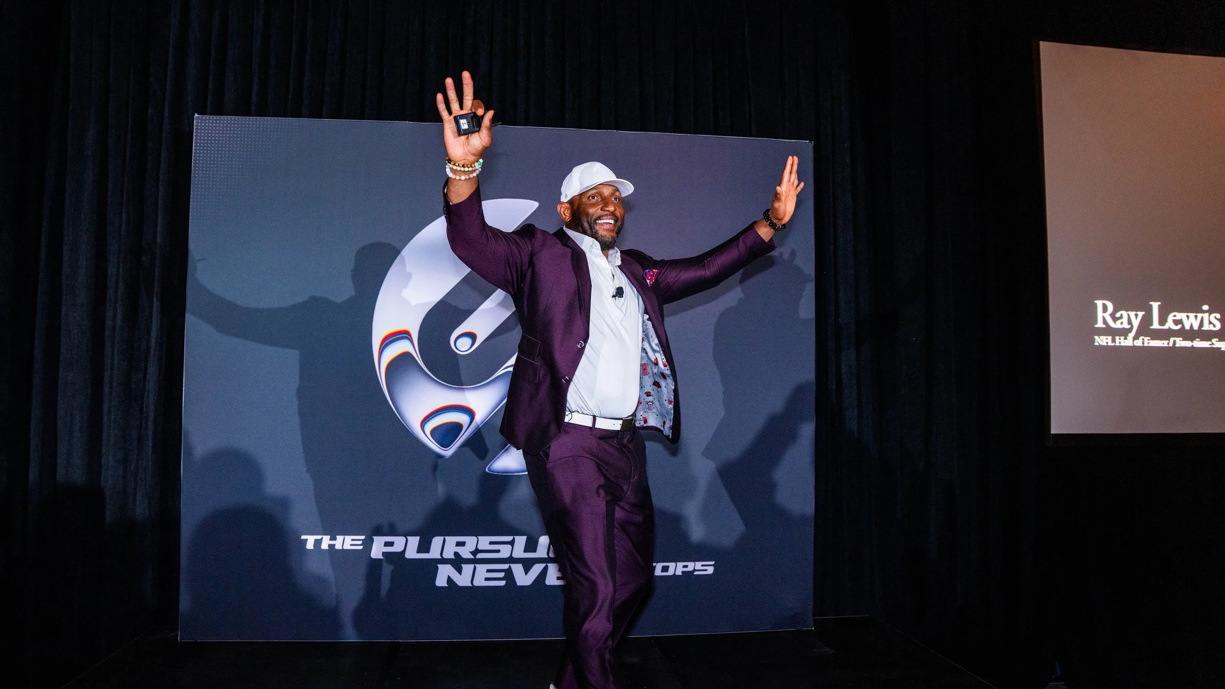 NFL Hall of Famer Ray Lewis speaking on stage at the Supra Human Elite Fly-In leadership event in Scottsdale produced by Wife of the Party.