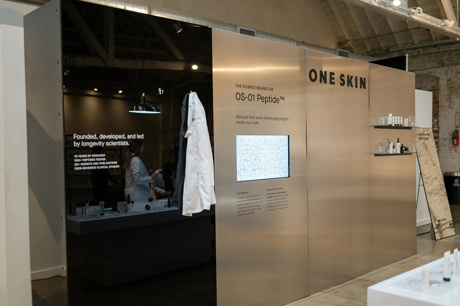 OneSkin product education display showcasing skincare benefits at influencer brand event produced by The Wife of the Party