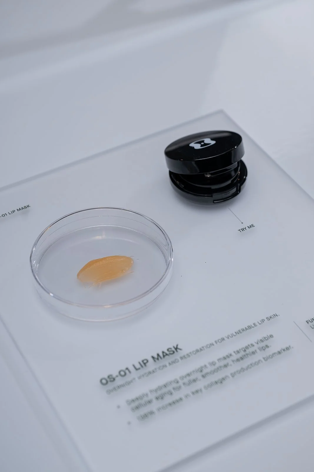 OneSkin OS-01 Lip Mask showcased in minimal display for hands-on guest experience