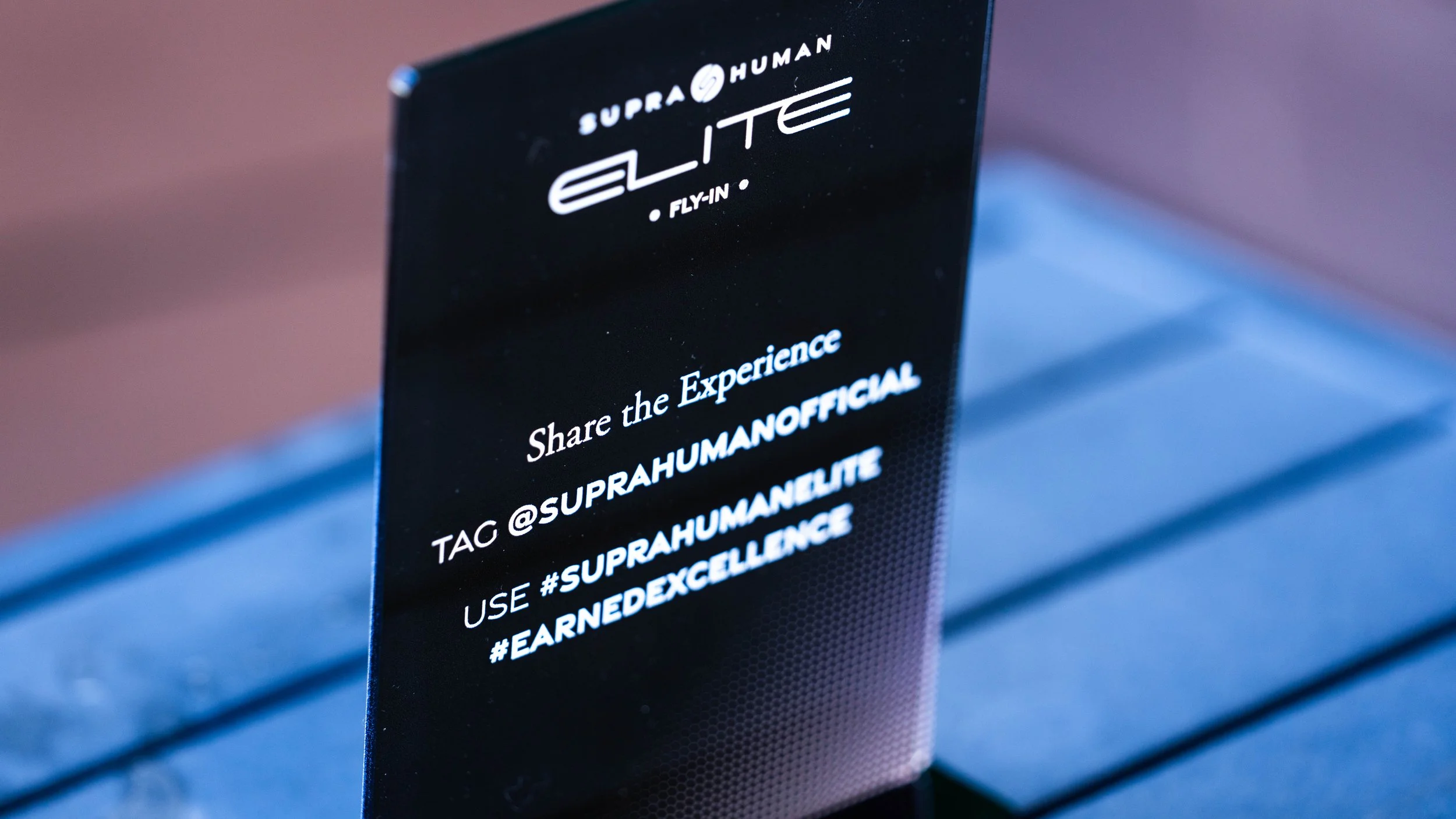 Supra Human Elite Fly-In branded welcome signage encouraging guests to share the experience at a Scottsdale corporate event produced by Wife of the Party.