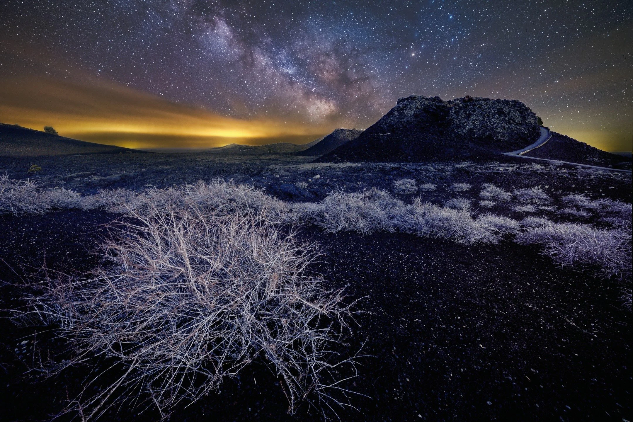 From long ago and far away. A personal project that was never edited until today. 

Craters of the Moon is a giant field of lava flow with some old remaining cinder cones and lots and lots of black lava rock. 

It makes the foreground a little freaky