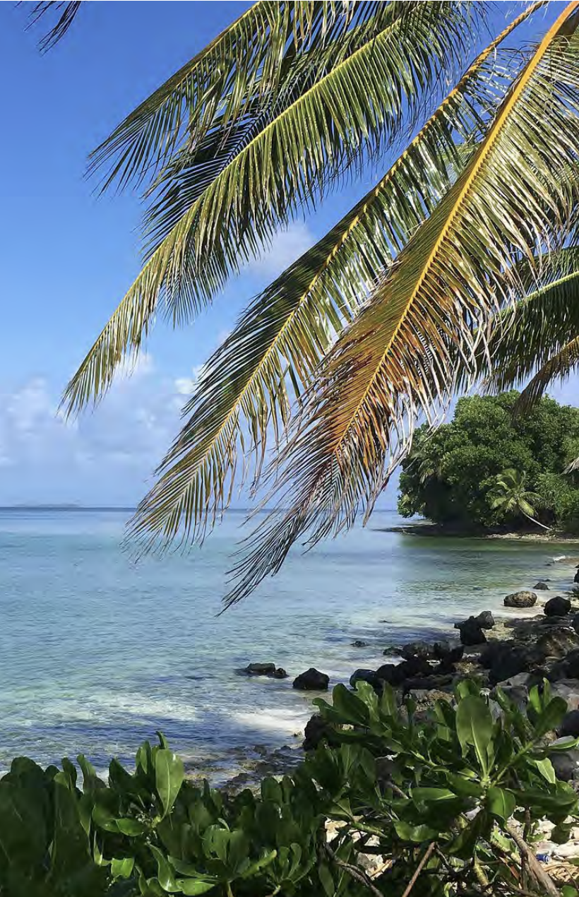 Aerial view of low-lying Fogafale on Funafuti Atoll, Tuvalu, surrounded by the Pacific Ocean and lagoon.