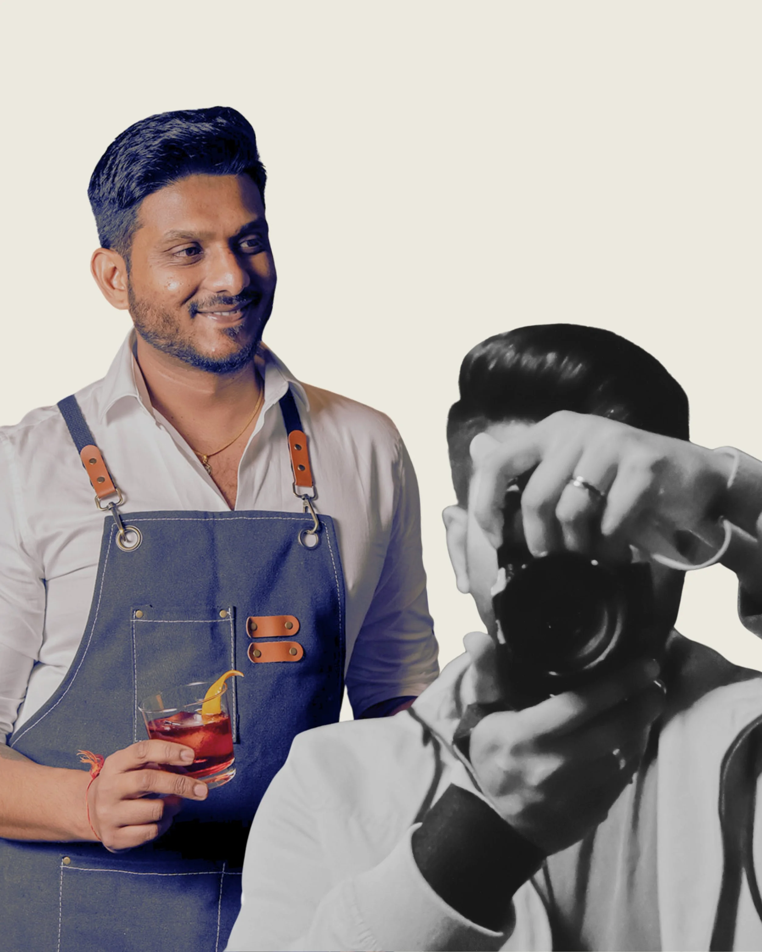 Smiling man with dark hair and beard holding a cocktail with orange fruit, wearing a white shirt and blue apron, standing next to another person with black hair covering part of his face in black and white
