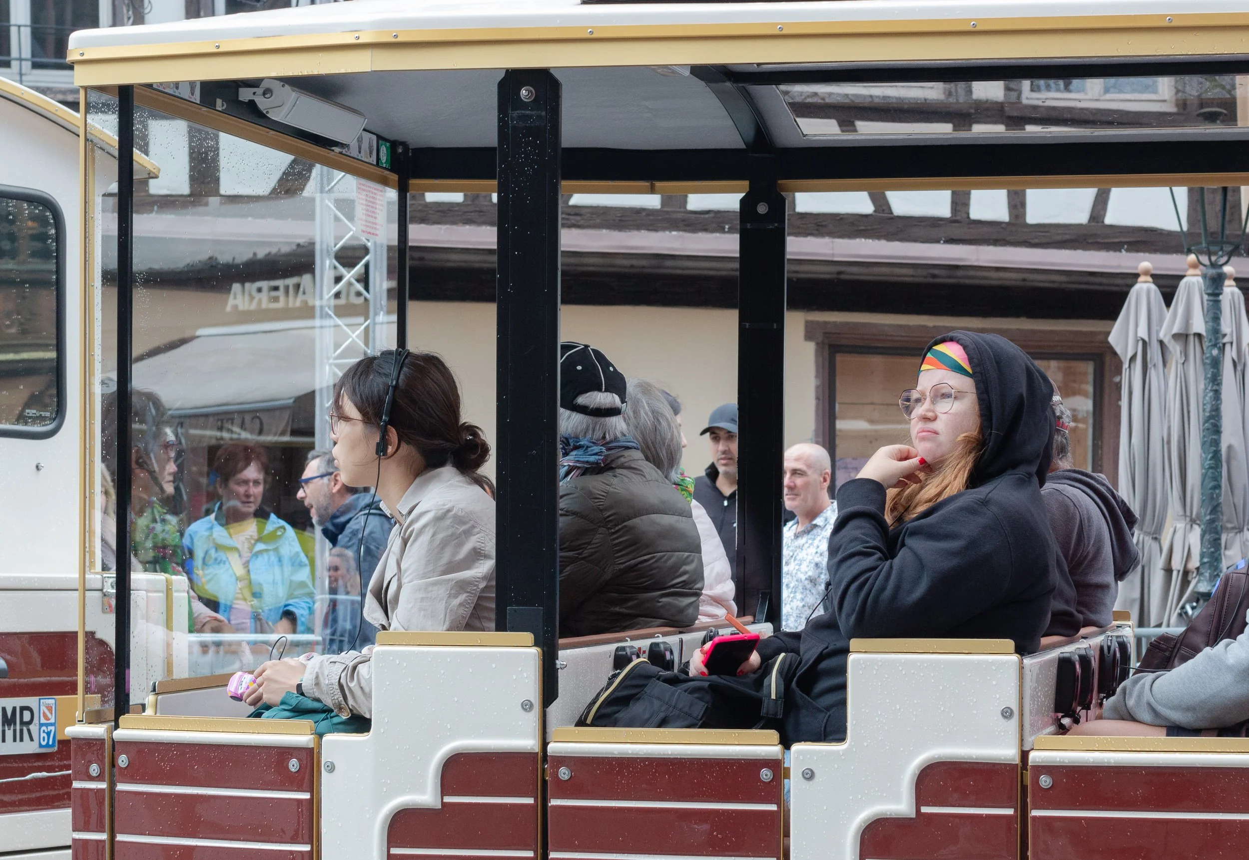 Passengers sitting in a tourist train in central Strasbourg.