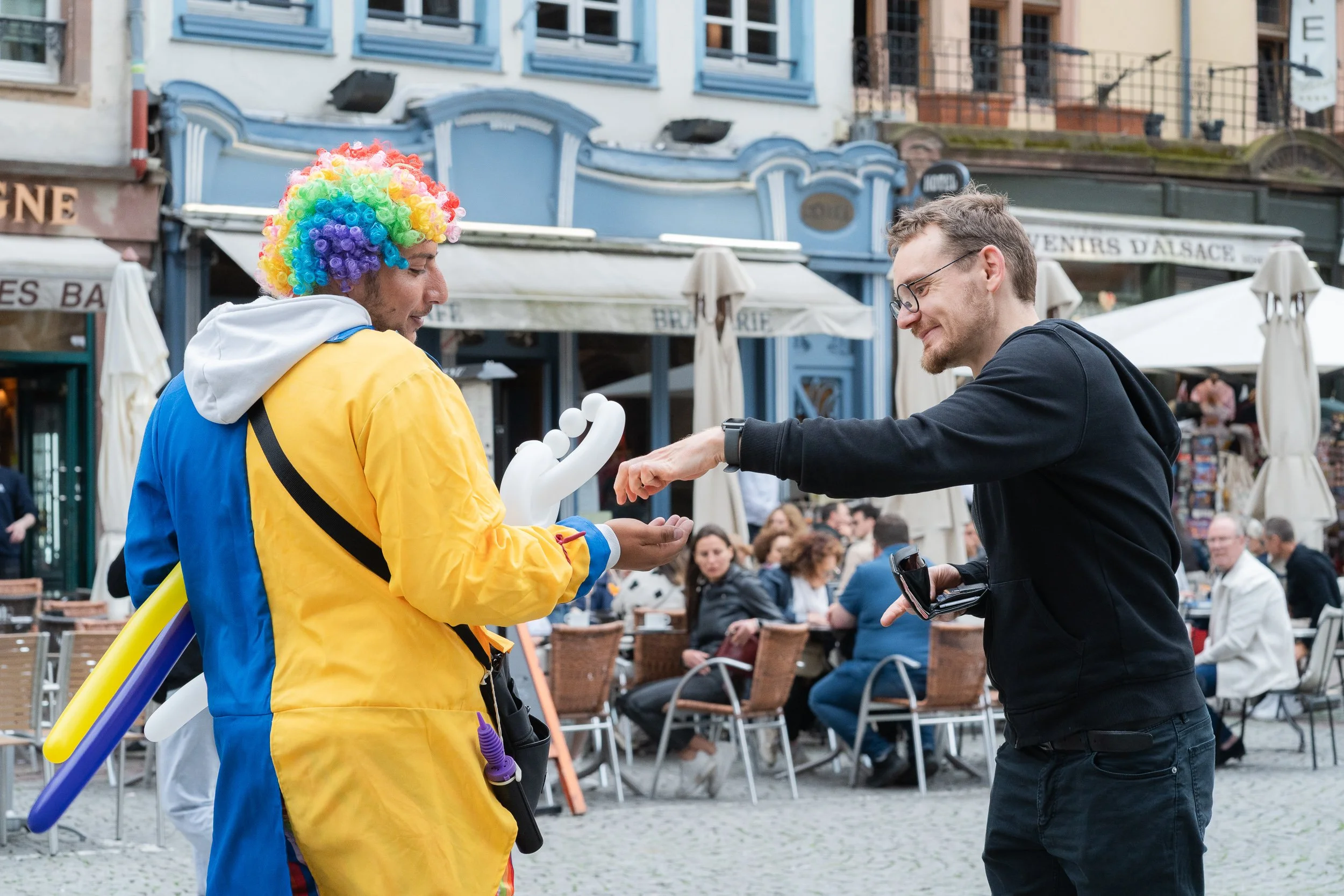 Balloon performer interacting with a passer-by in central Strasbourg.