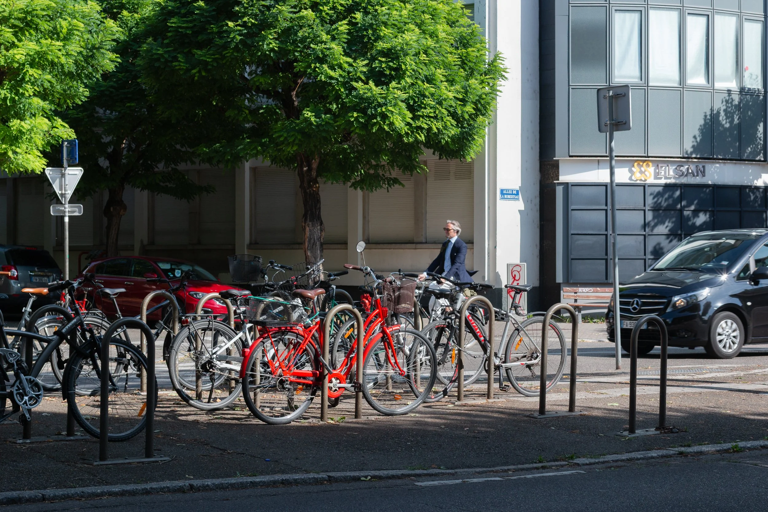 Large group of bicycles crowded around street racks in Strasbourg.