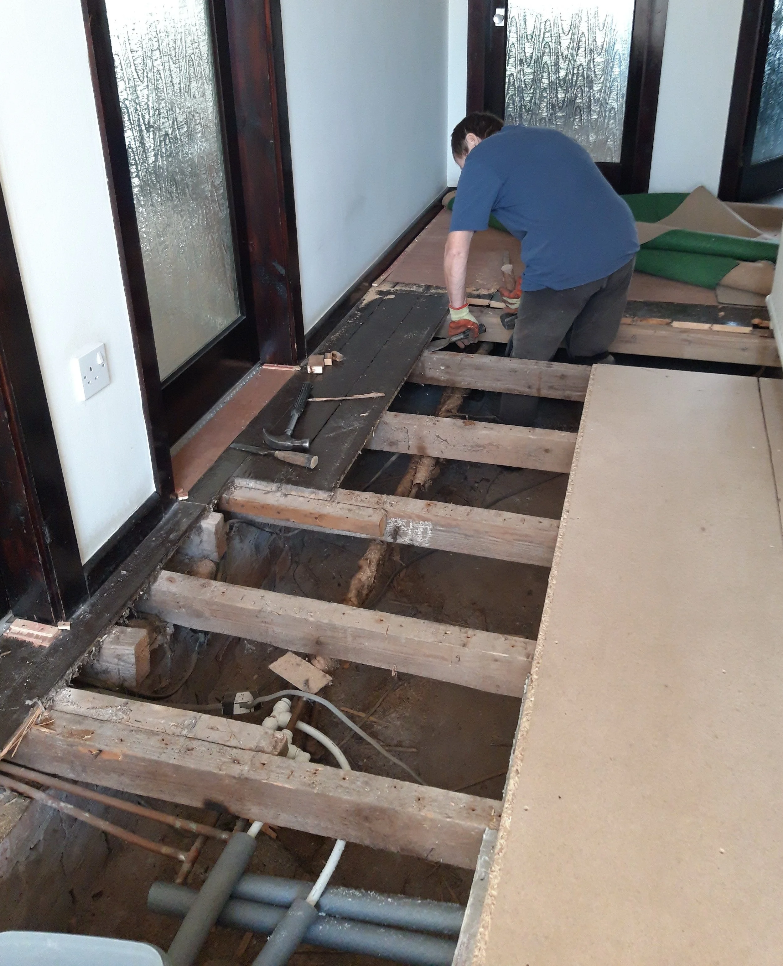 Removing old floorboards re lagging pipes before fitting underfloor insulation and thermal boards.jpg