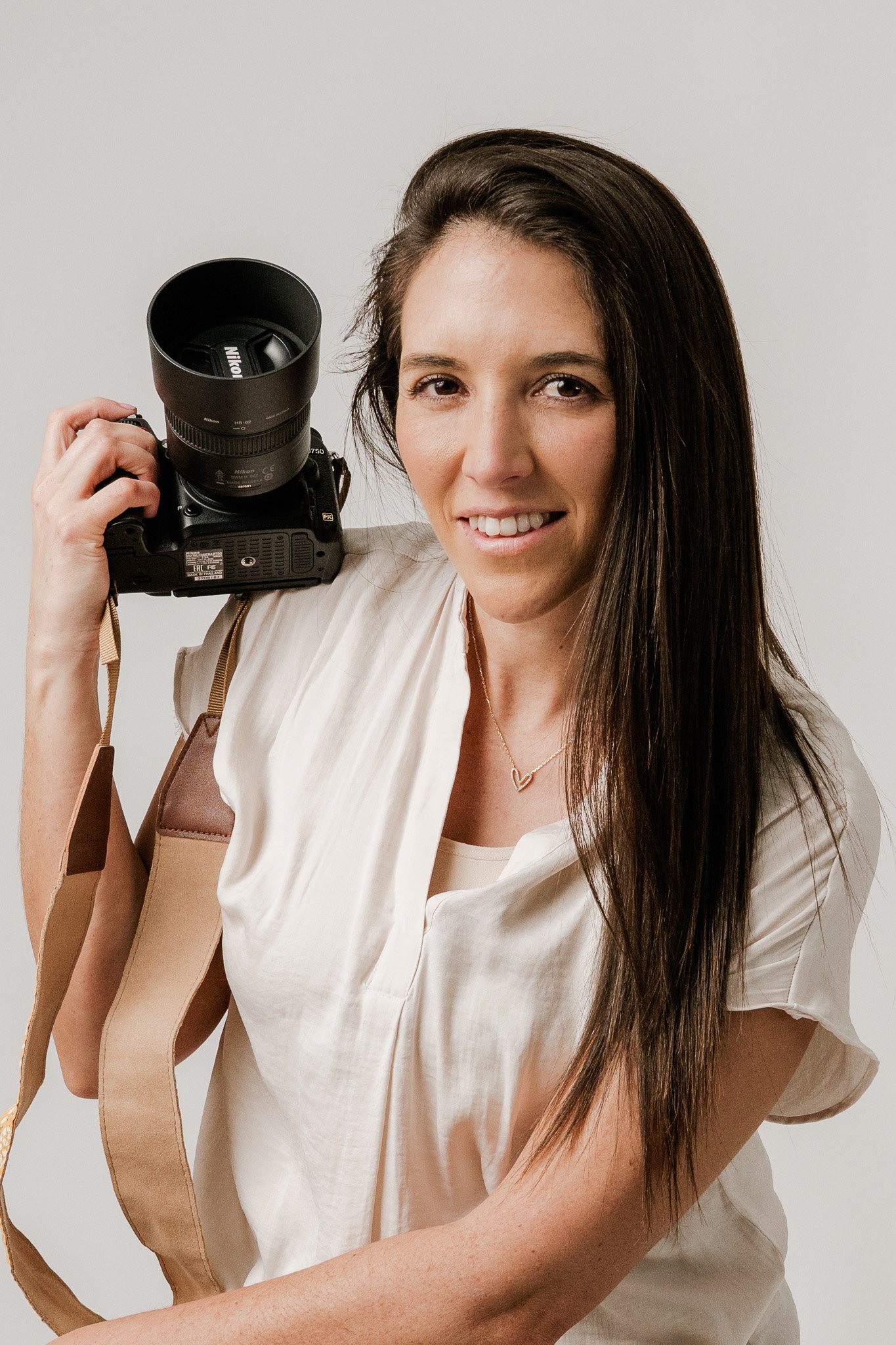 Portrait of photographer, based in Rochester Hills, Michigan, smiling and looking directly at the camera.