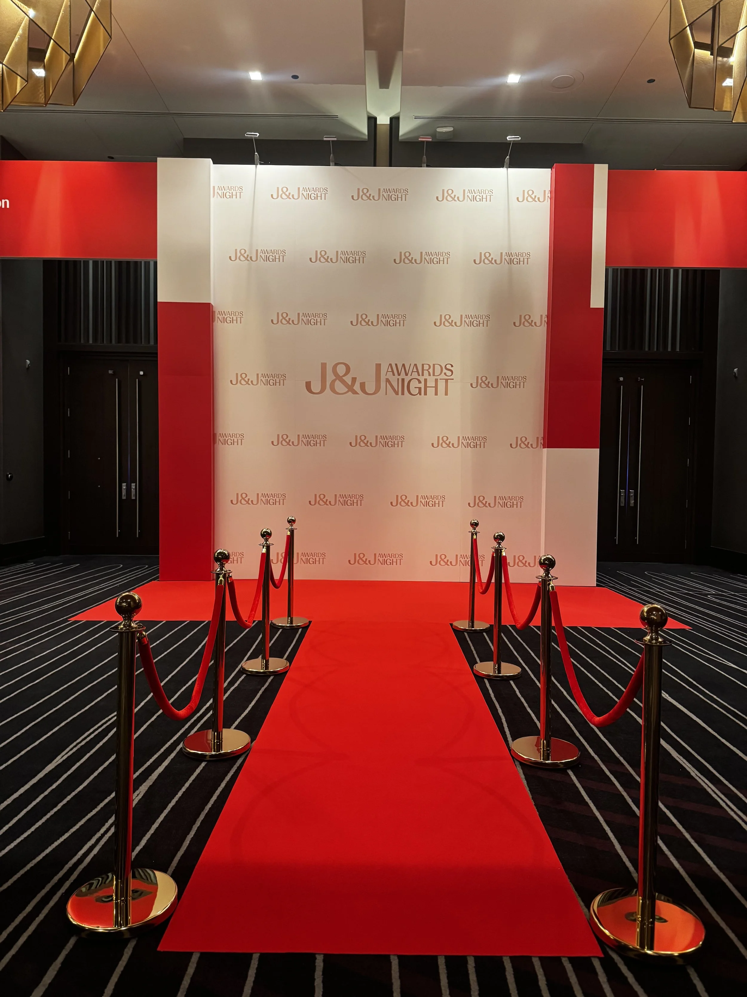 Grand entrance with step-and-repeat backdrop for Johnson & Johnson Awards Night at Grand Hyatt Nashville, designed by Charlie Grey Events.