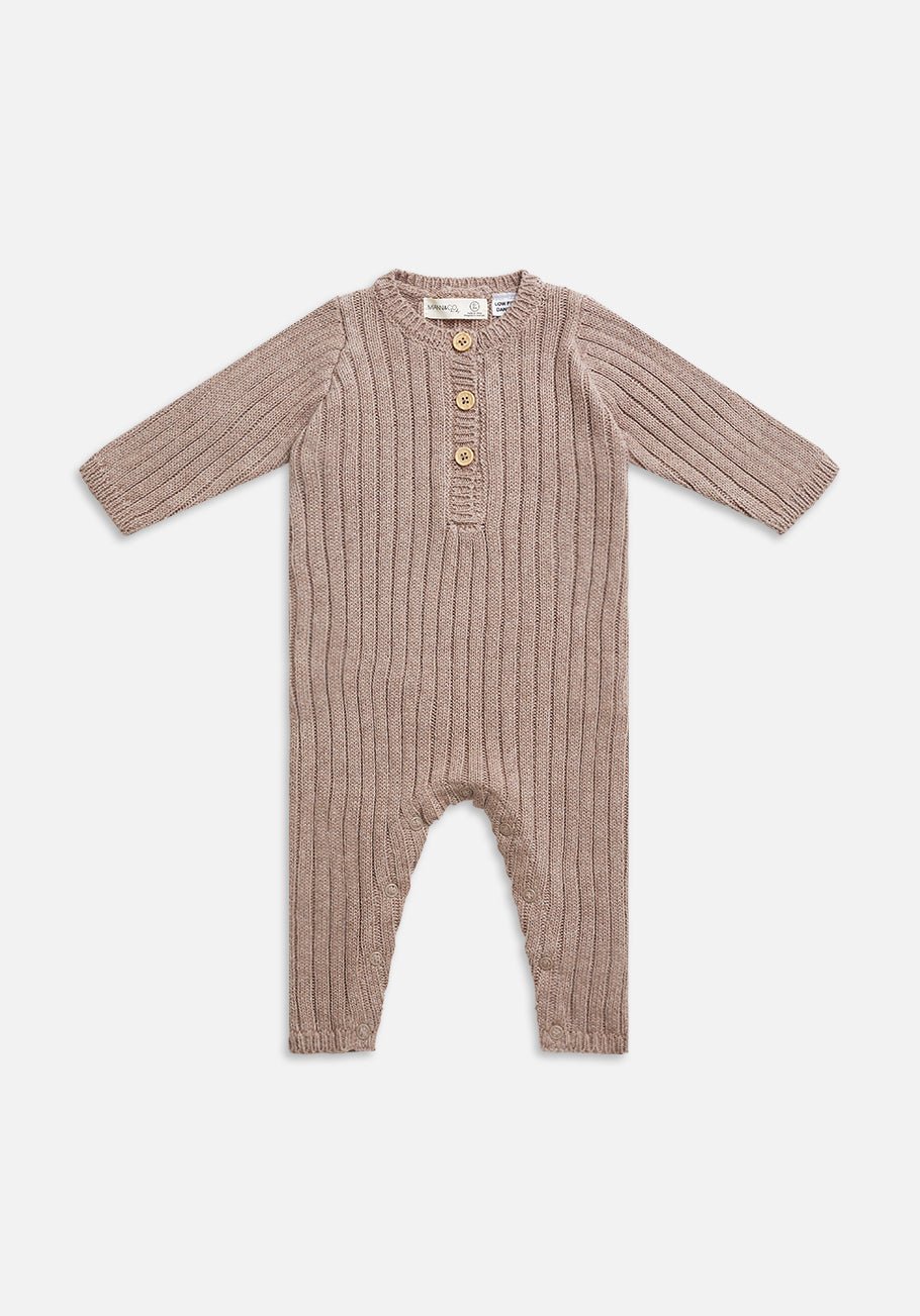 Beige knitted baby onesie with long sleeves, ribbed pattern, and four buttons on the front.