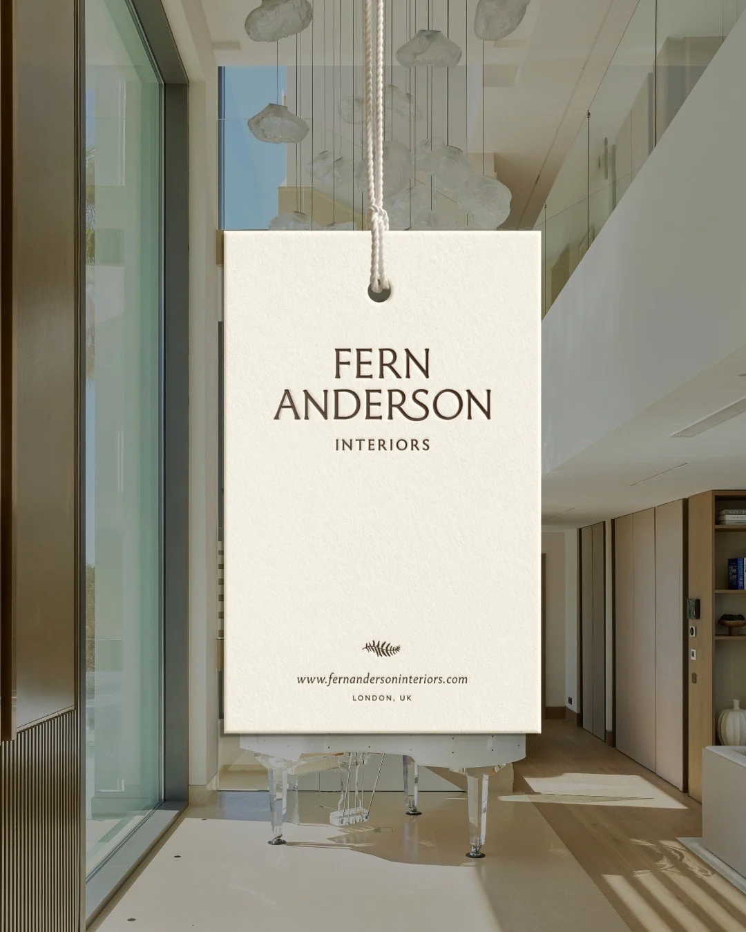 Fern Anderson Interiors brochure cover featuring the studio wordmark over an interior project with a pendant sphere light, designed by The Brand Muse for the founder-led interior design studio.