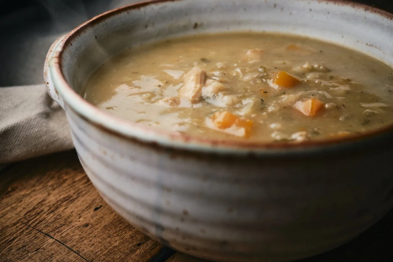 salmon chowder with sweet potato in a rustic bowl
