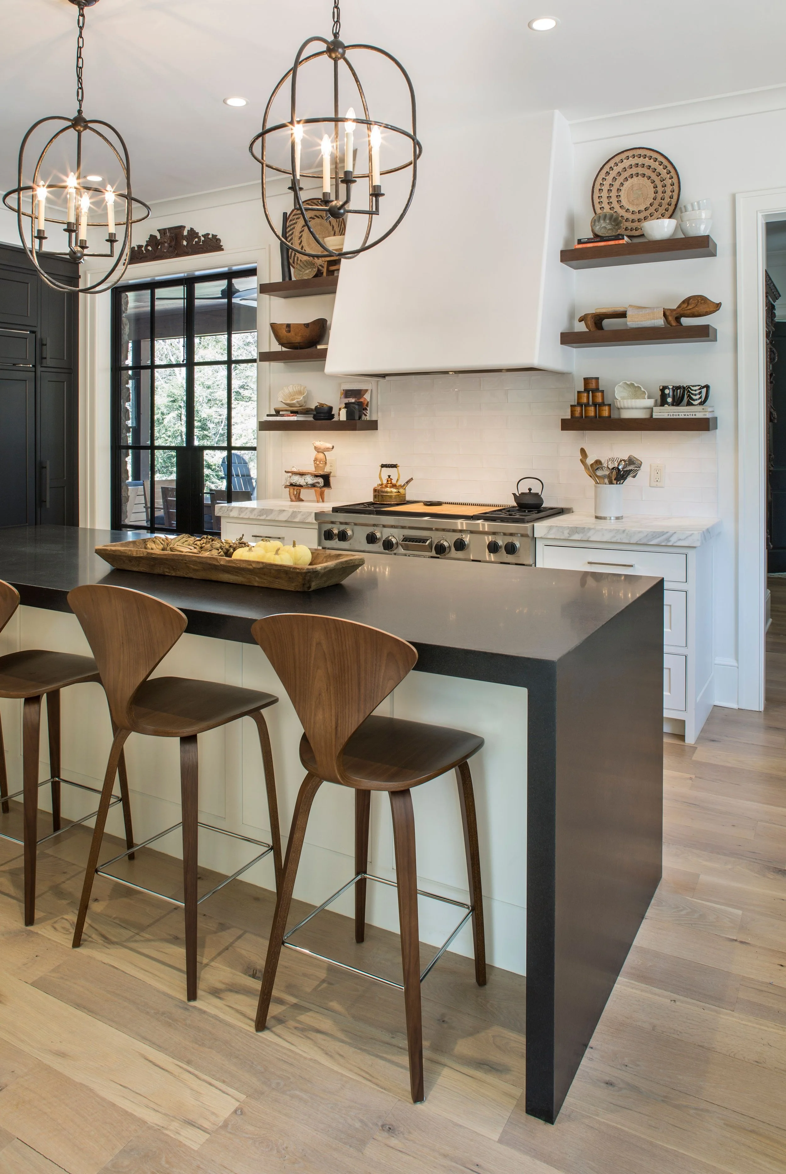 Natural stone and quartz mitered waterfall custom countertops and white panel cabinets
