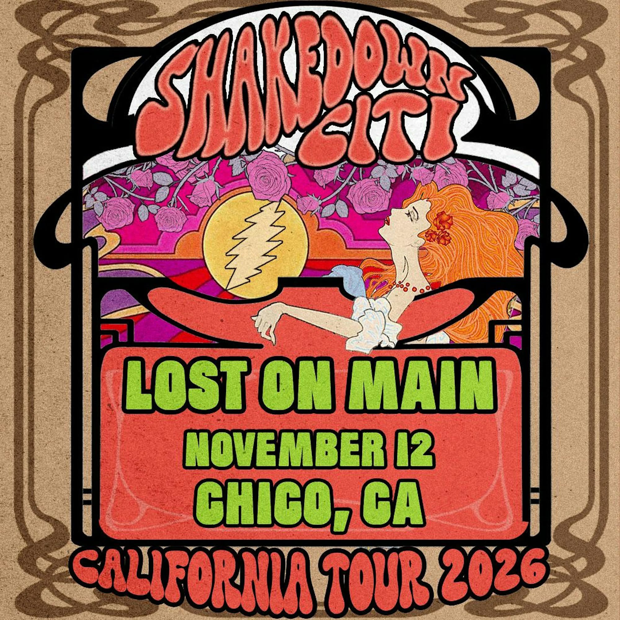 Alt text (full version):   Colorful psychedelic concert poster for Shakedown City featuring a red‑haired woman dancing beneath a lightning‑bolt skull emblem. The background bursts with vivid pink, orange, and purple hues framed by ornate tan borders.