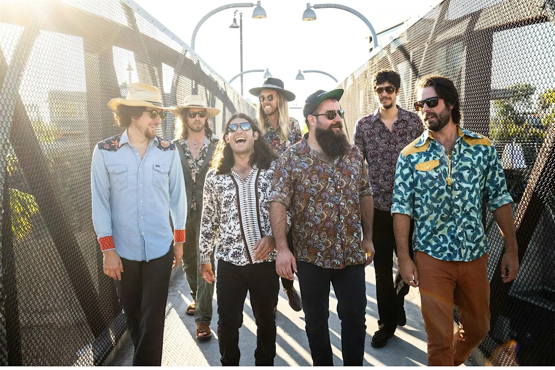 the band Diggin Dirt photographed in front of  a green roll-up door, 