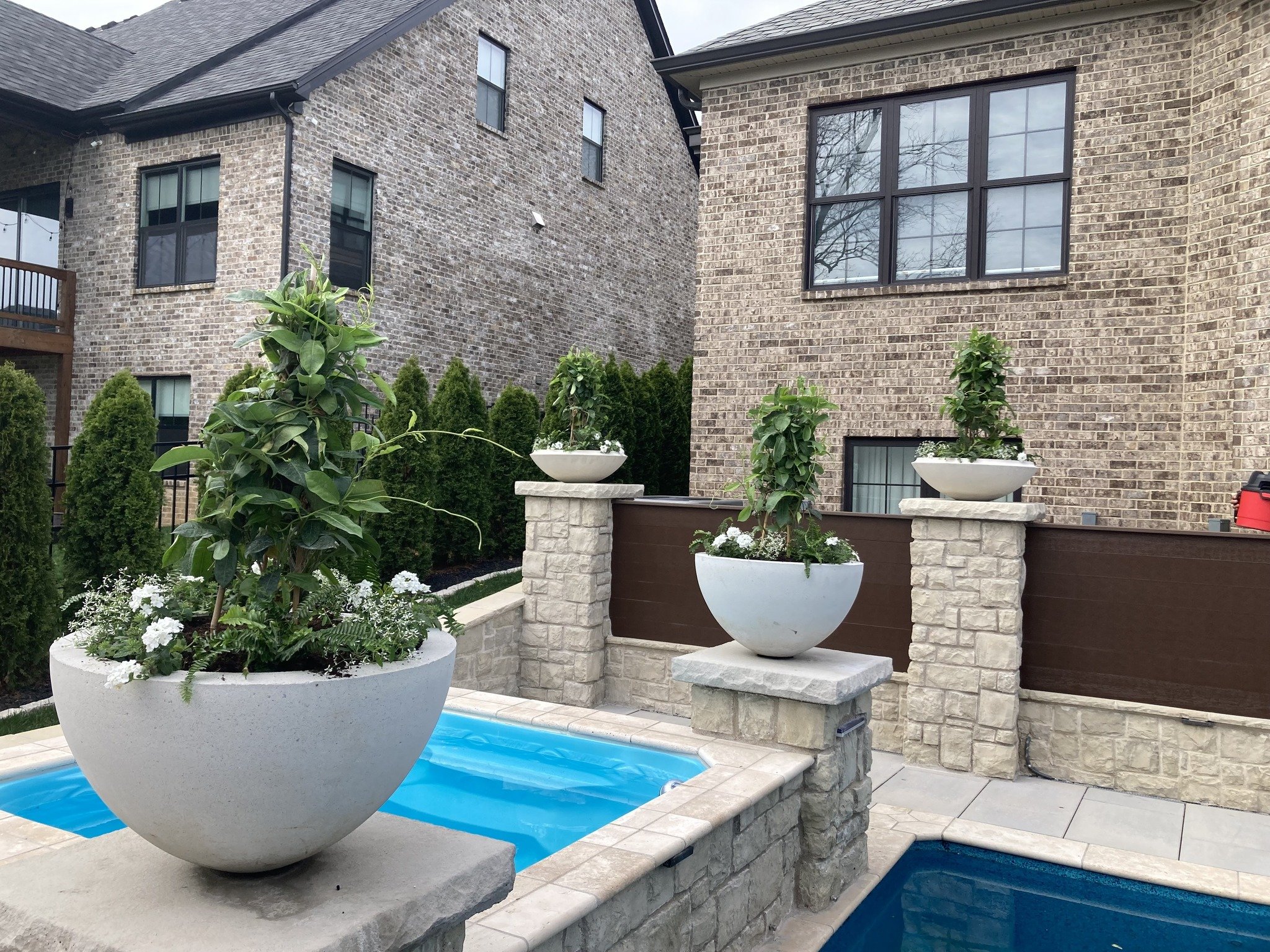 These custom cement pots full of luscious plants are just what was needed to finish up our latest pool project.

#customlandscape 
#swimmingpool 
#swimmingpooltime 
#outdoorliving 
#backyardoasis 
#BackyardDesign