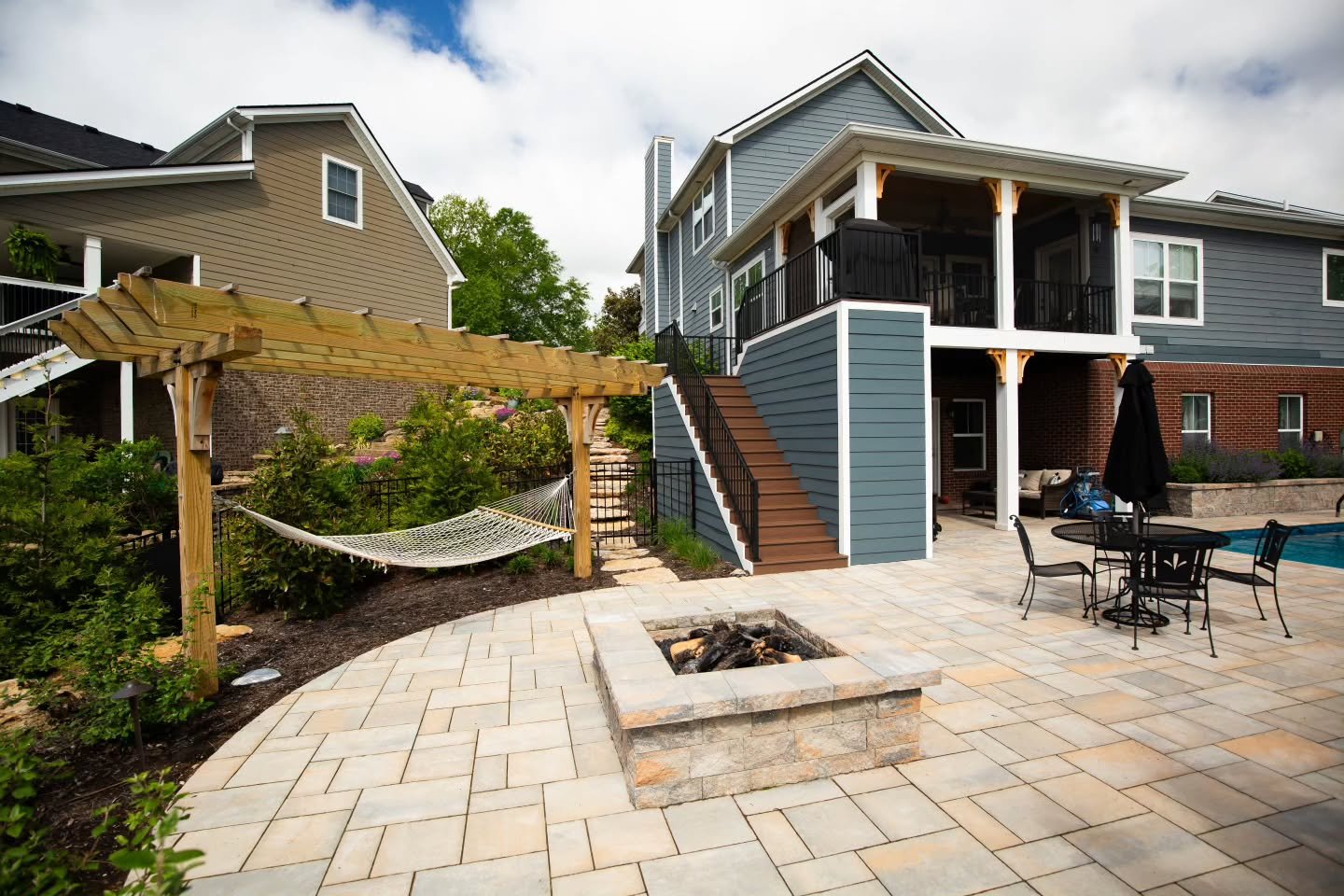 This backyard transformation includes a custom paver patio, built-in fire pit, pergola with hammock, and a seamless connection to the pool&mdash;blending relaxation, entertainment, and timeless design.

Every element was built to fit the way this fam