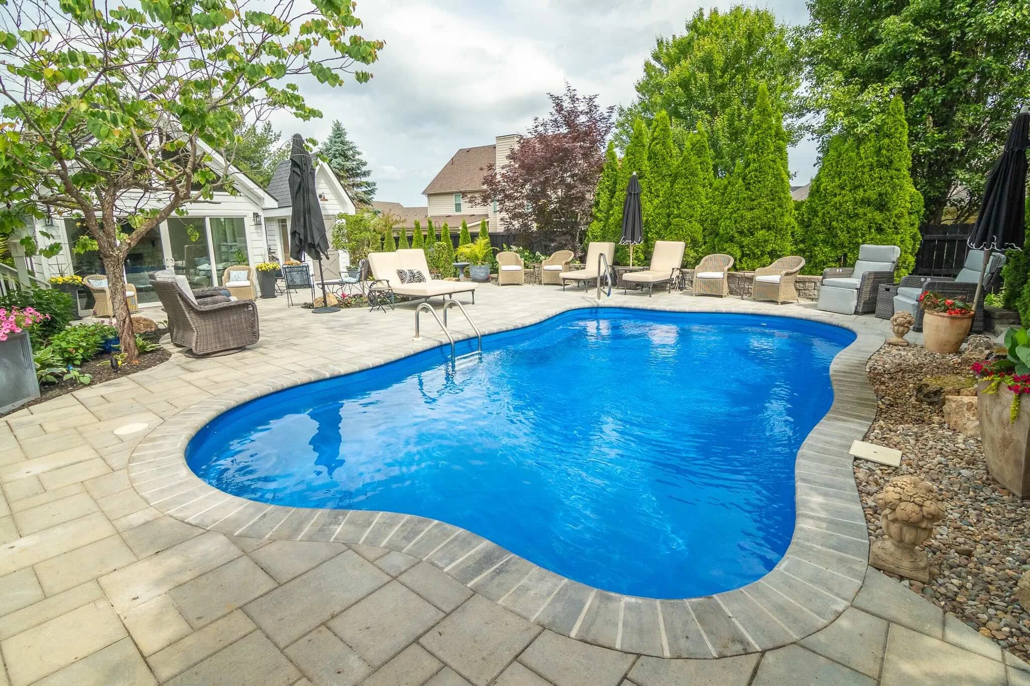 Outdoor living space, pool, pool deck, landscape design, water feature