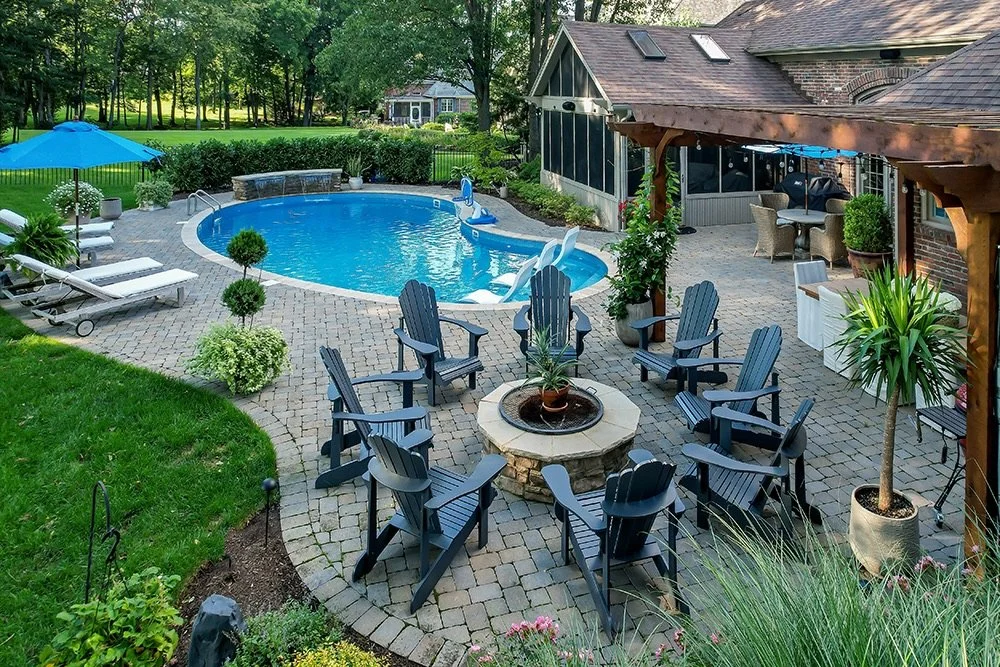 Outdoor design with pool, firepit, plantings, paver pool deck.
