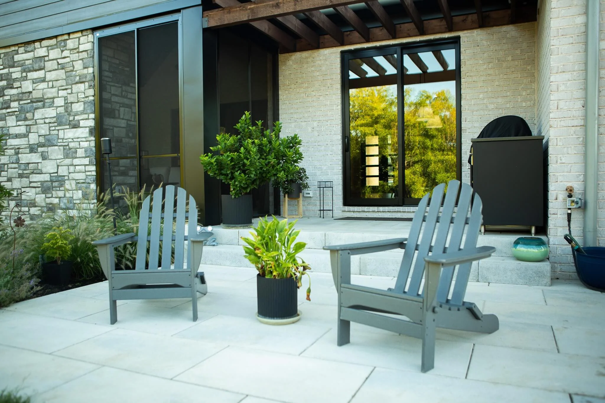 Simple modern patio space off the back door, adjacent to pool space. 