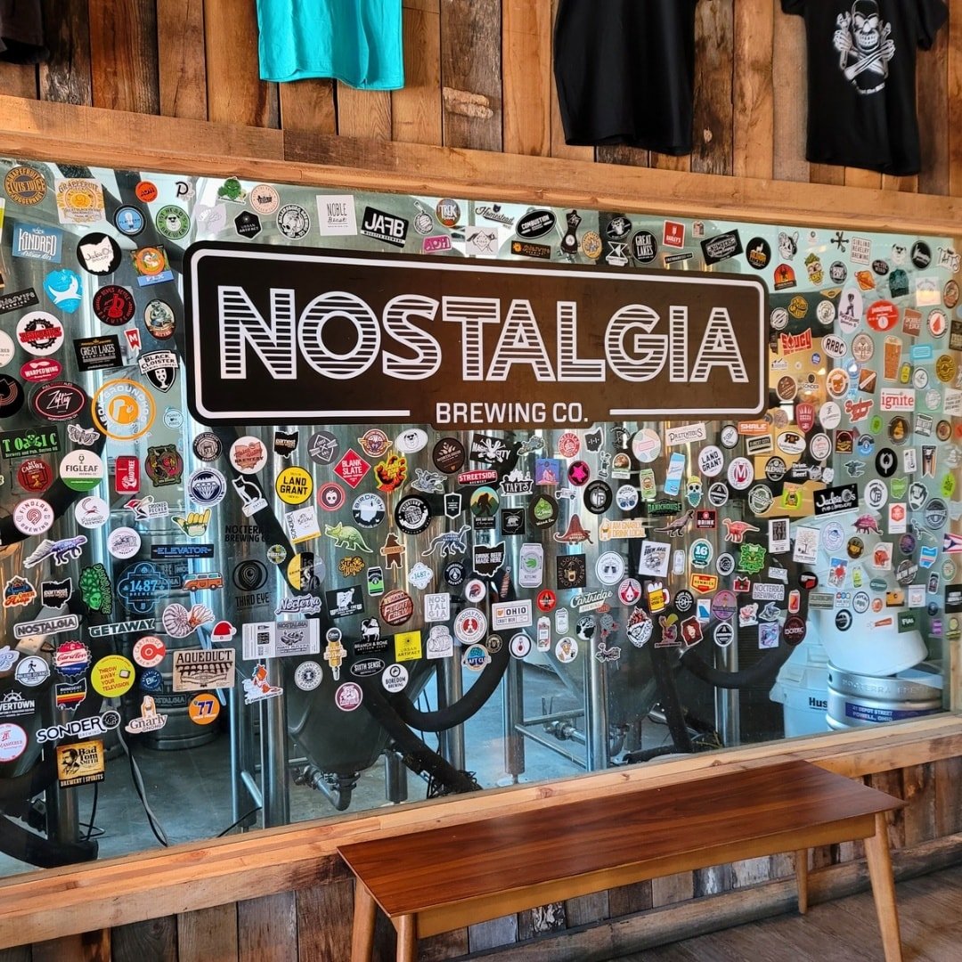 This wall? It&rsquo;s basically a scrapbook of good times.

From local legends to traveling taproom visitors, our brewery window is layered with memories, milestones, and moments shared together. That&rsquo;s what Nostalgia is all about! Bringing peo