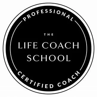 A circular logo with a black background and white text that reads "The Life Coach School. Certified Coach. Professional"