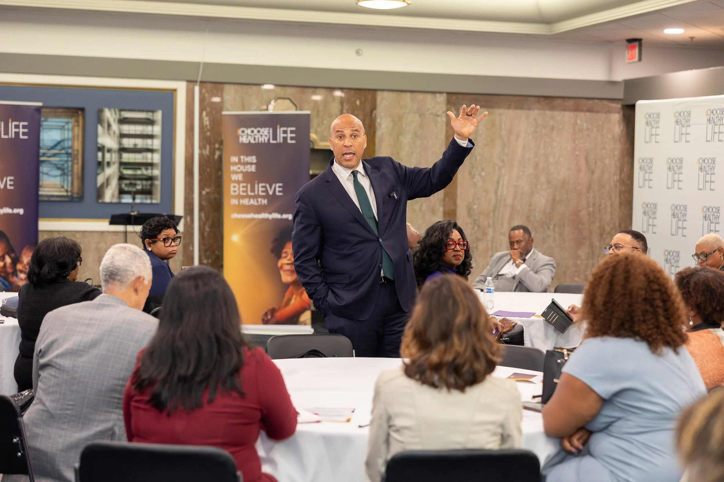Sen. Cory Booker (NJ) steps into the center of the room to deliver remarks