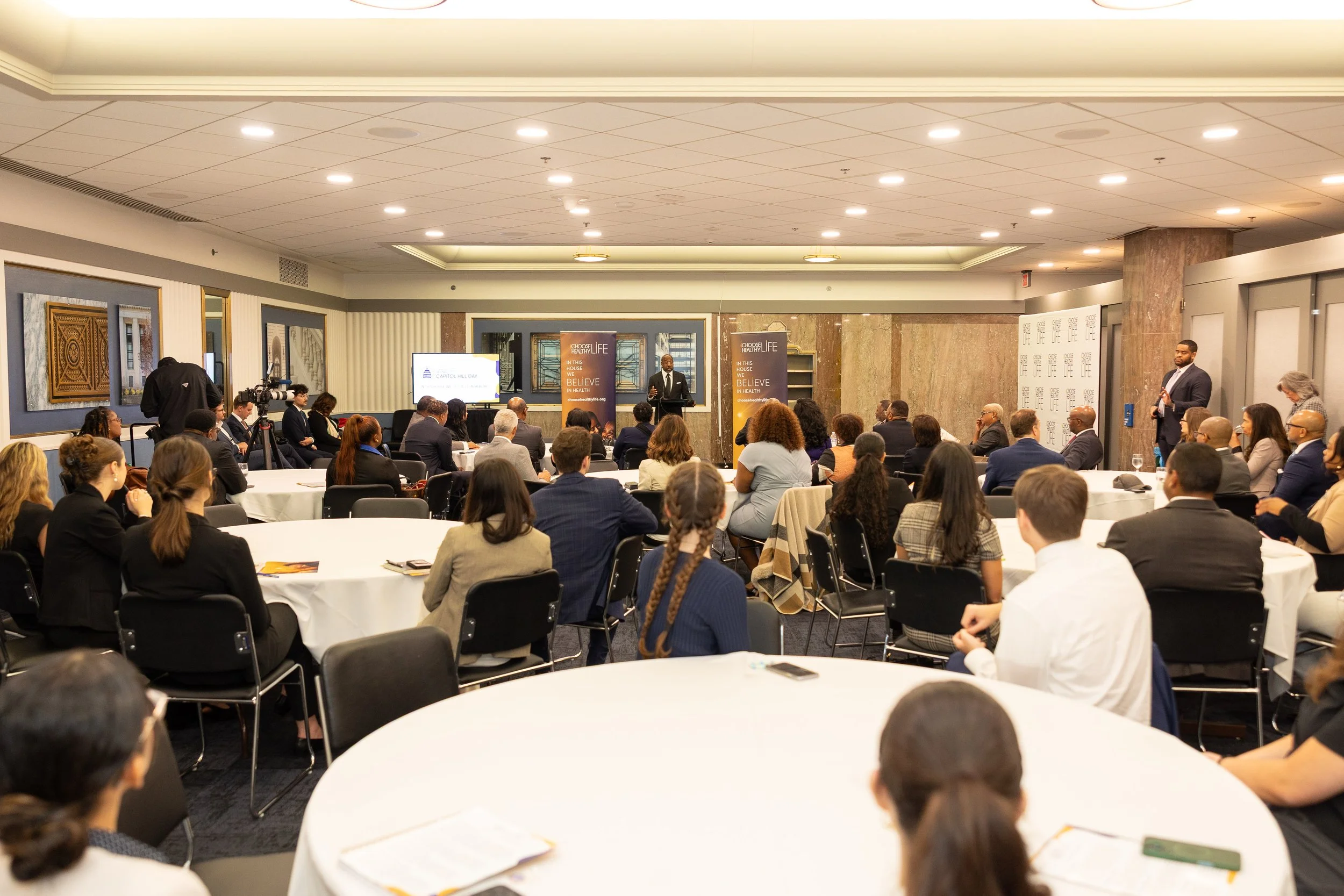Congressional Staffers from over 50 offices listen to remarks on current health legislation from Sen. Raphael Warnock (GA)