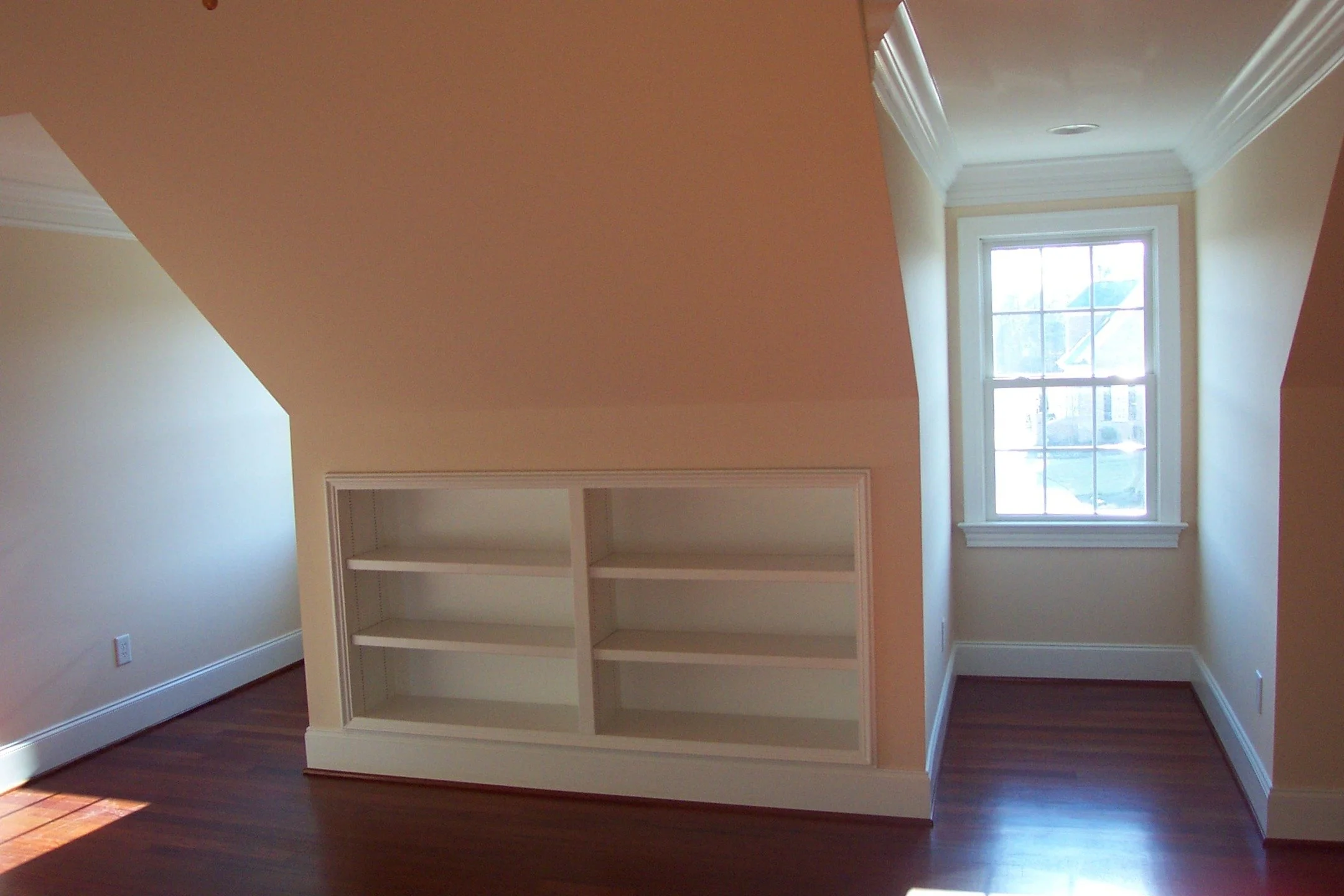Built-in bookshelves don't have to be large. In this children's room, we made the perfect spot for a book nook. 