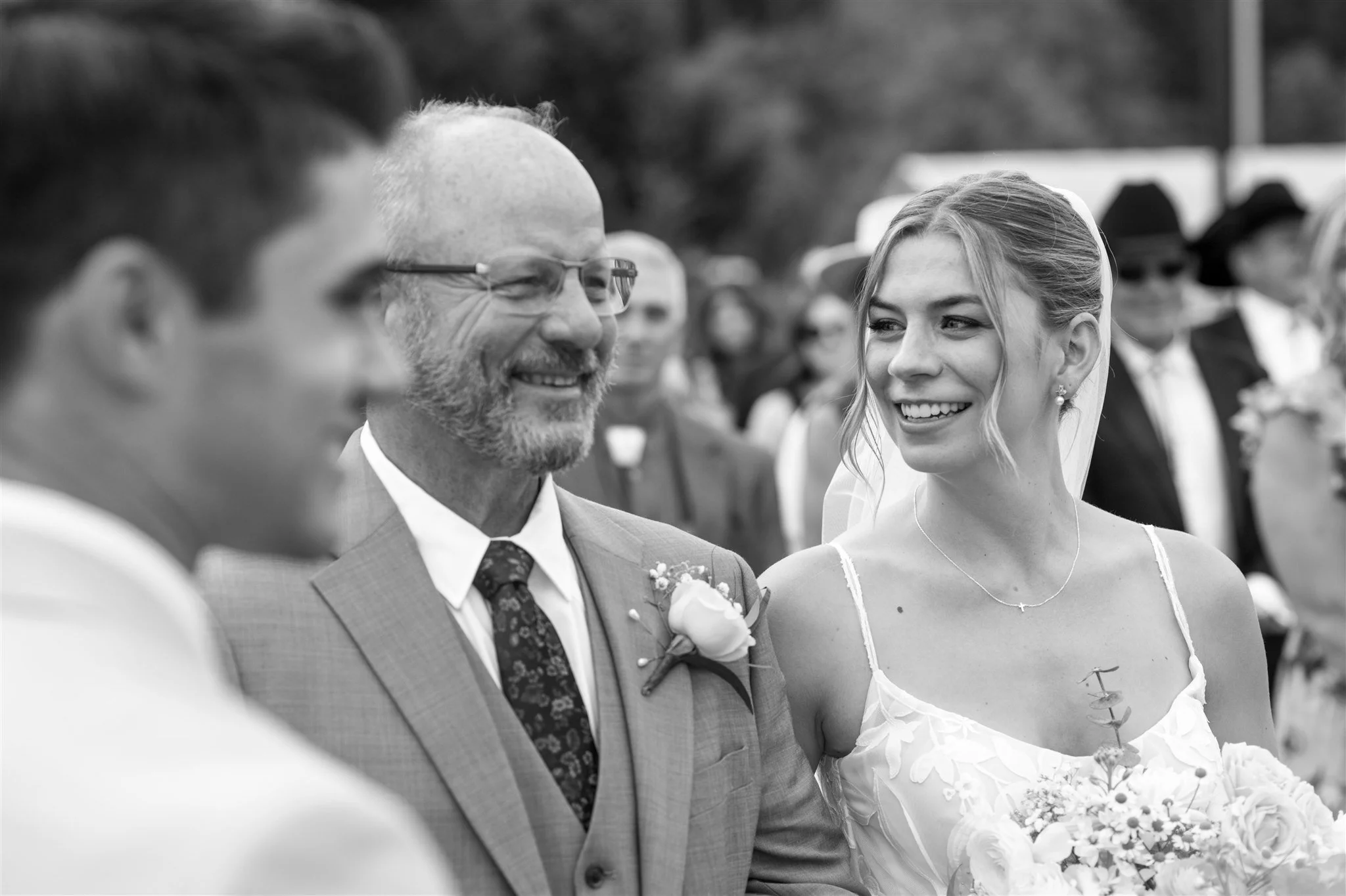 candid-father-of-the-bride-smiling-at-ceremony-black-and-white.jpg